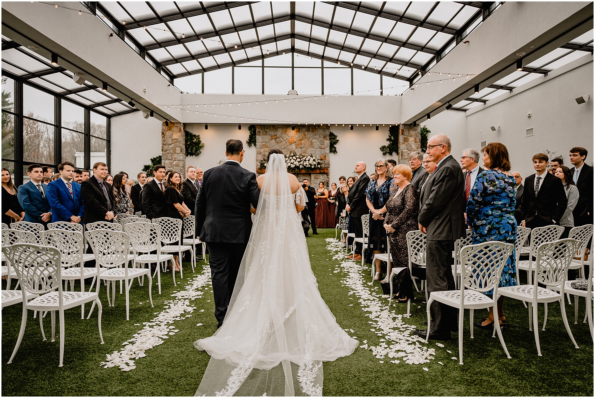 father escorts bride down the aisle for wedding ceremony in the atrium at Perona Farms Reserve