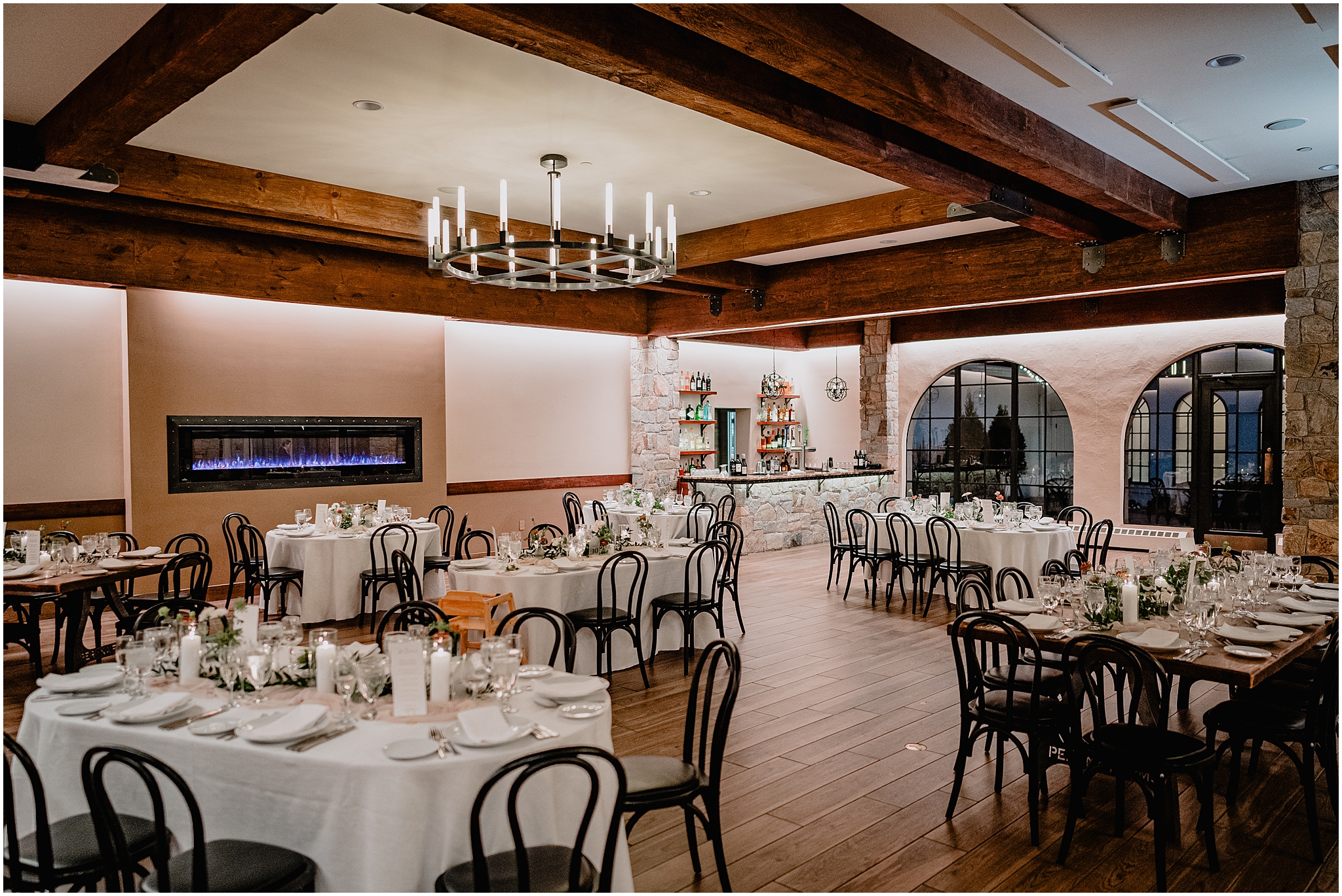 fall wedding reception at Perona Farms Reserve with white candles and greenery on wooden tables
