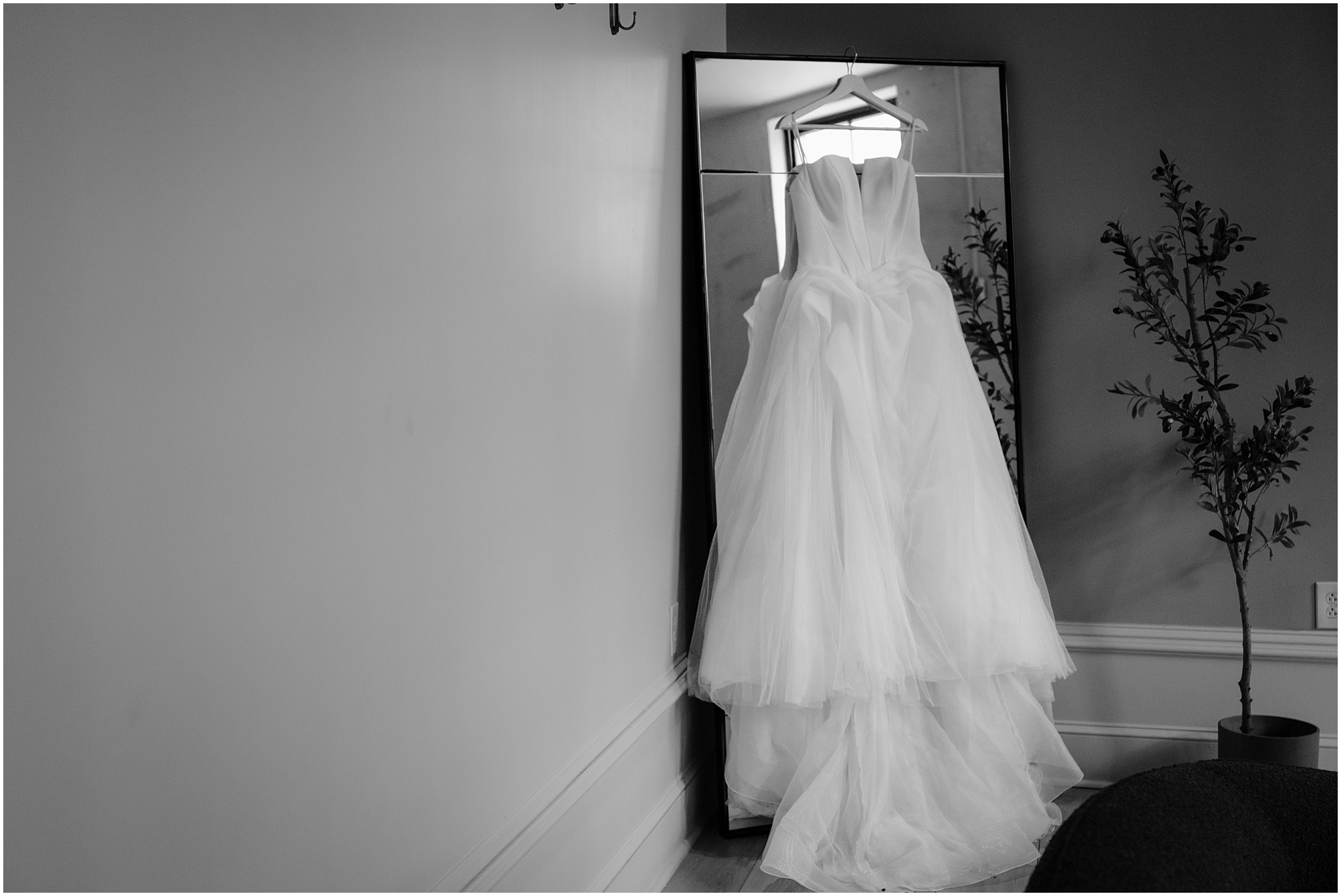 wedding dress hangs on mirror inside Philadelphia PA hotel 