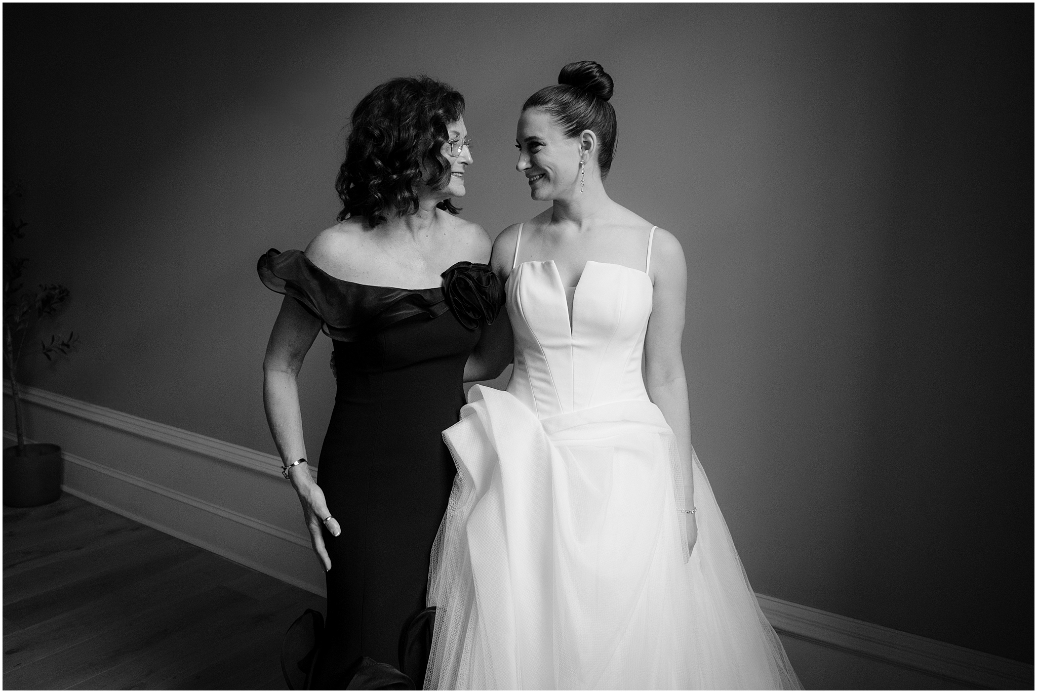 bride and mother smile at each other after prepping in Philadelphia PA hotel