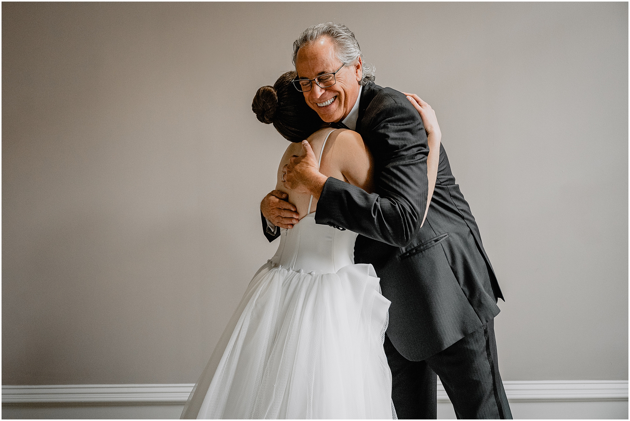 bride and dad hug during first look inside Philadelphia PA hotel