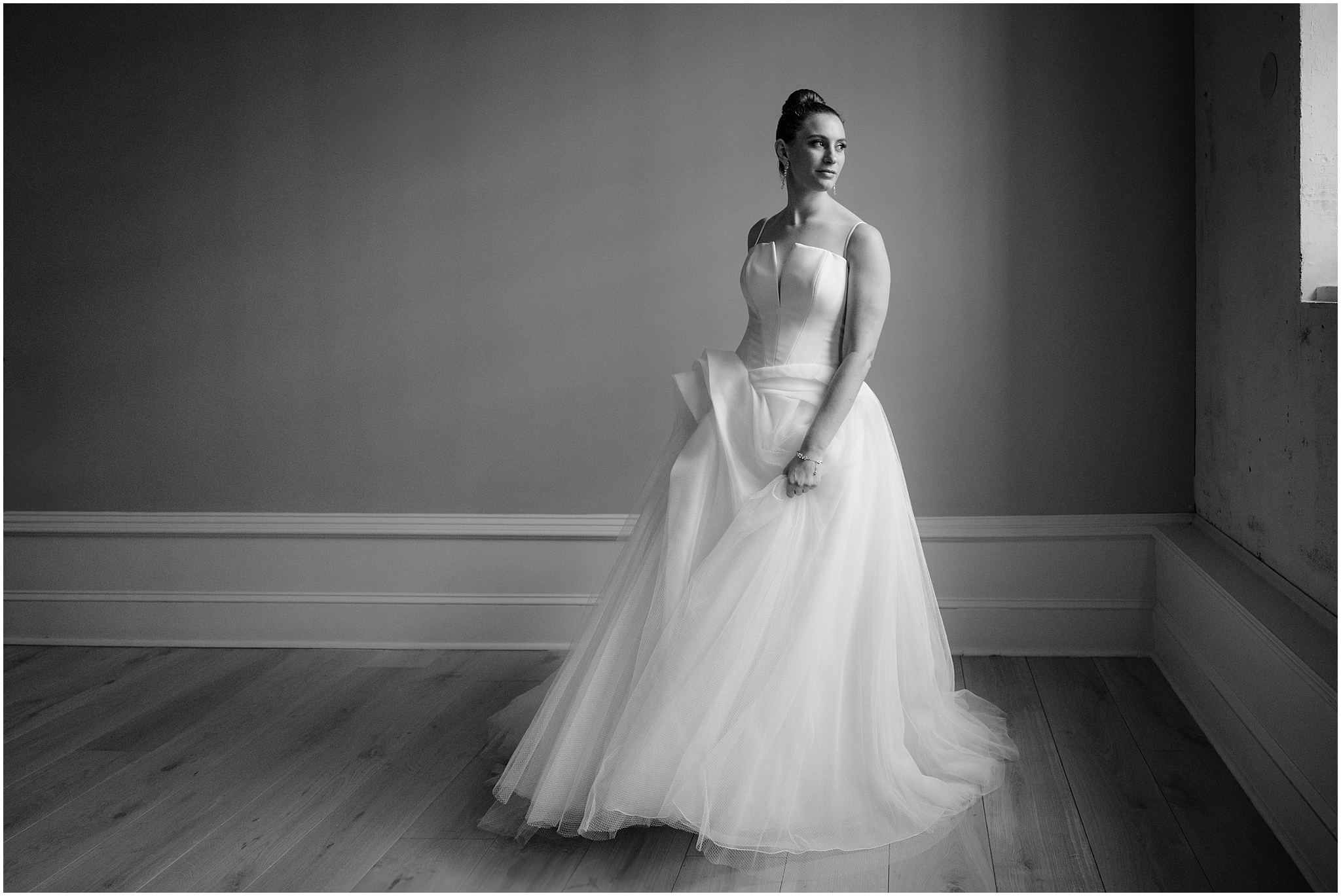 black and white portrait of bride twirling in wedding gown inside Philadelphia PA hotel