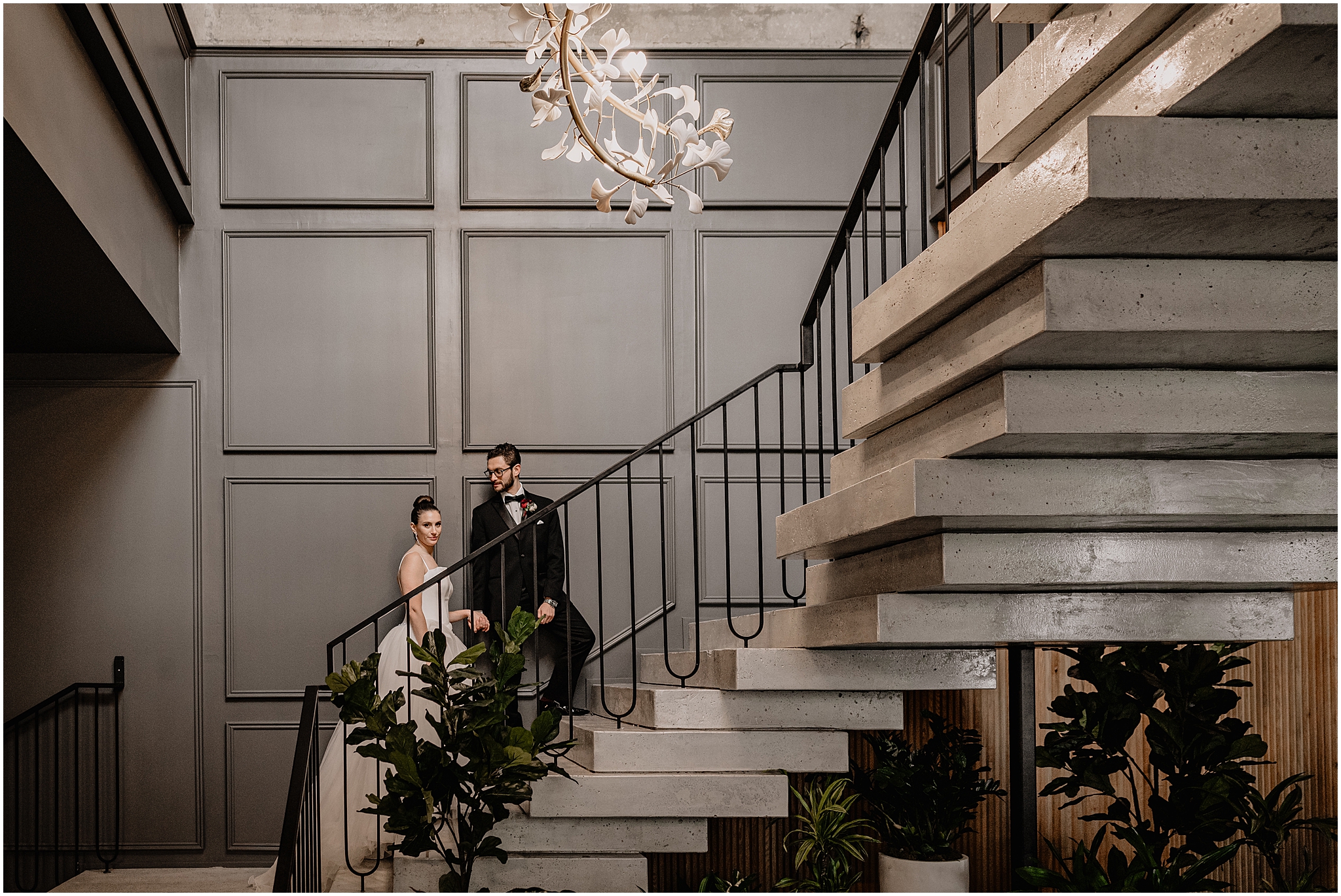 groom leads bride up staircase inside Cescaphe's Switch House in Philly PA