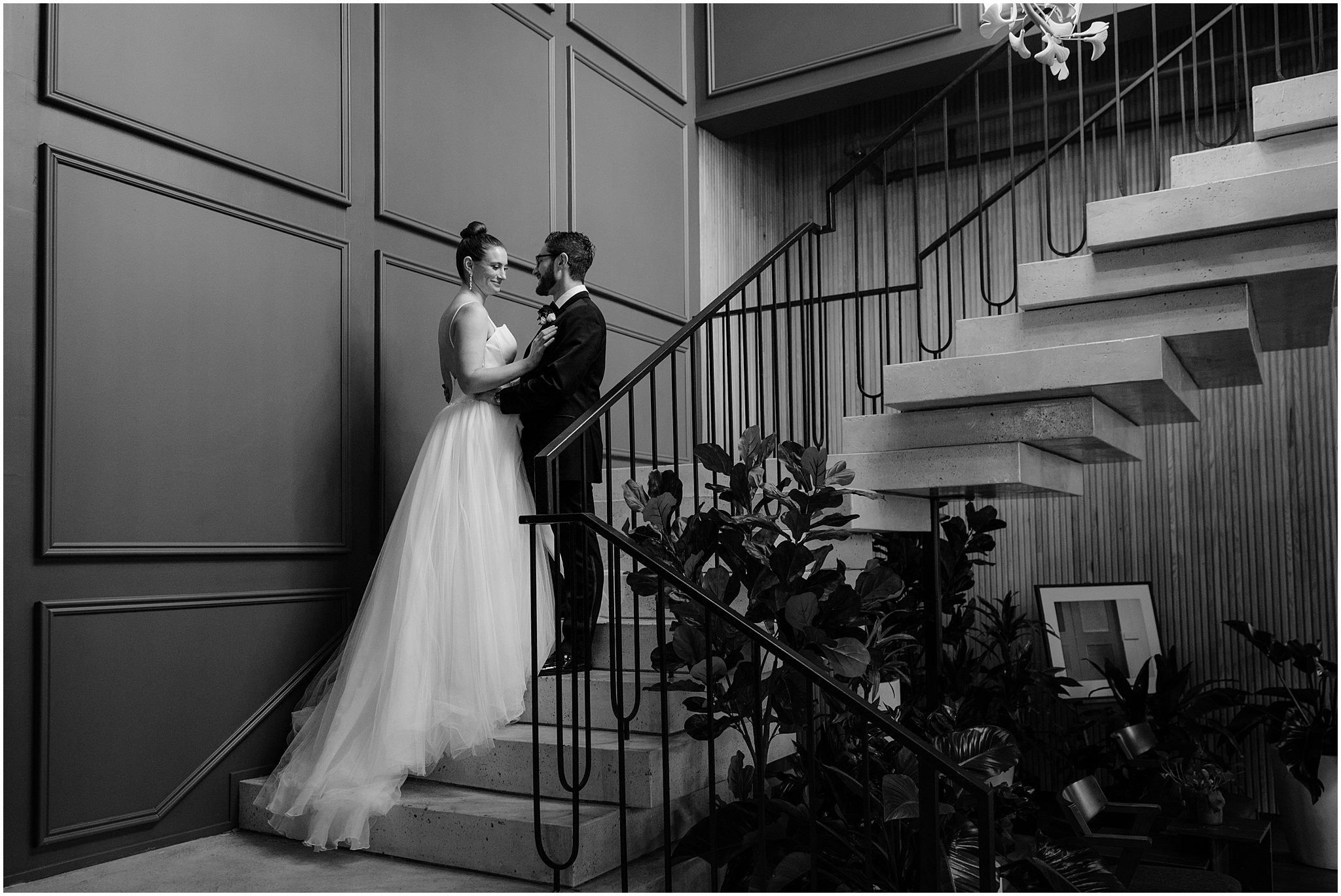 bride and groom stand on staircases inside Cescaphe's Switch House