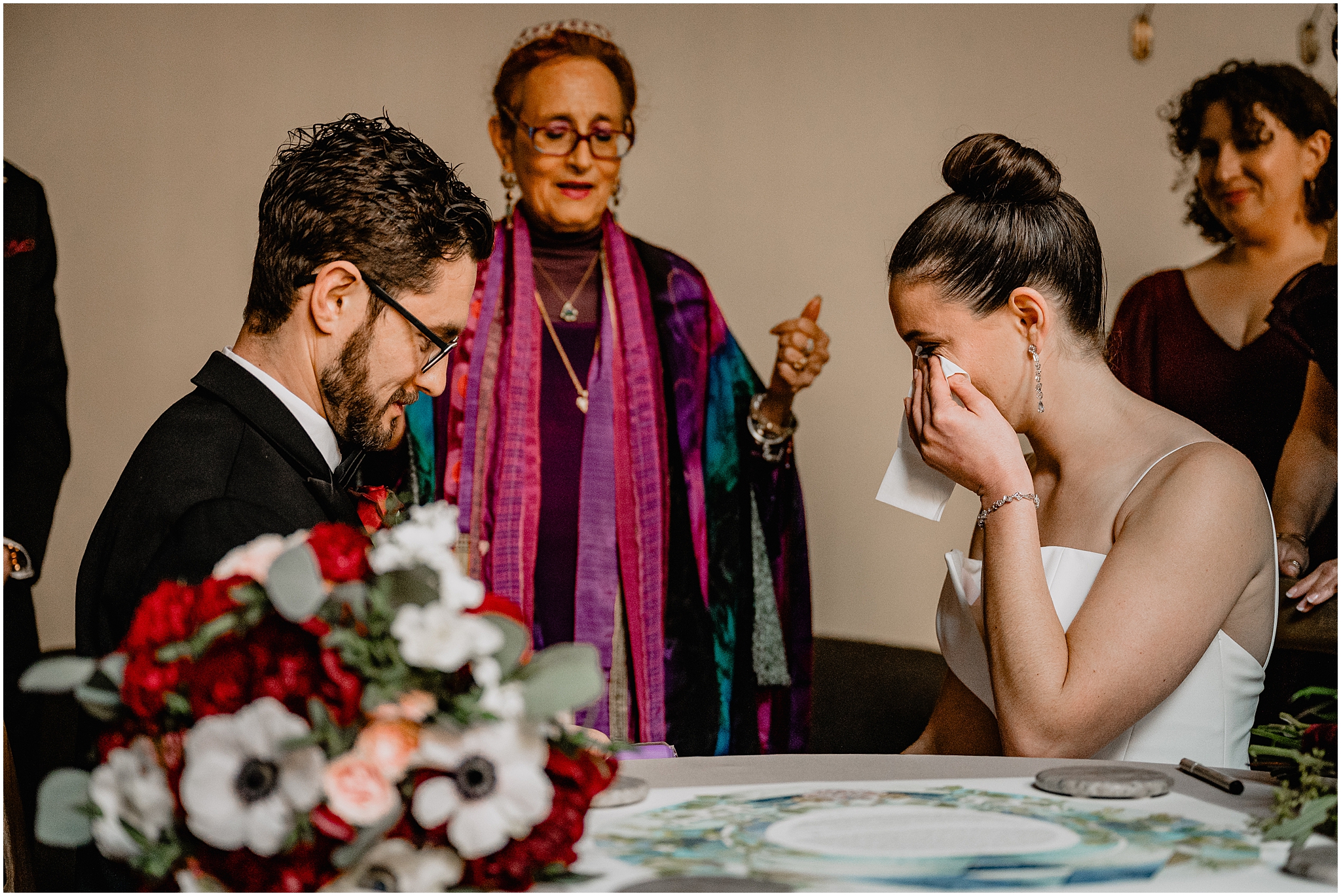 bride cries signing ketubah during wedding day at Cescaphe's Switch House