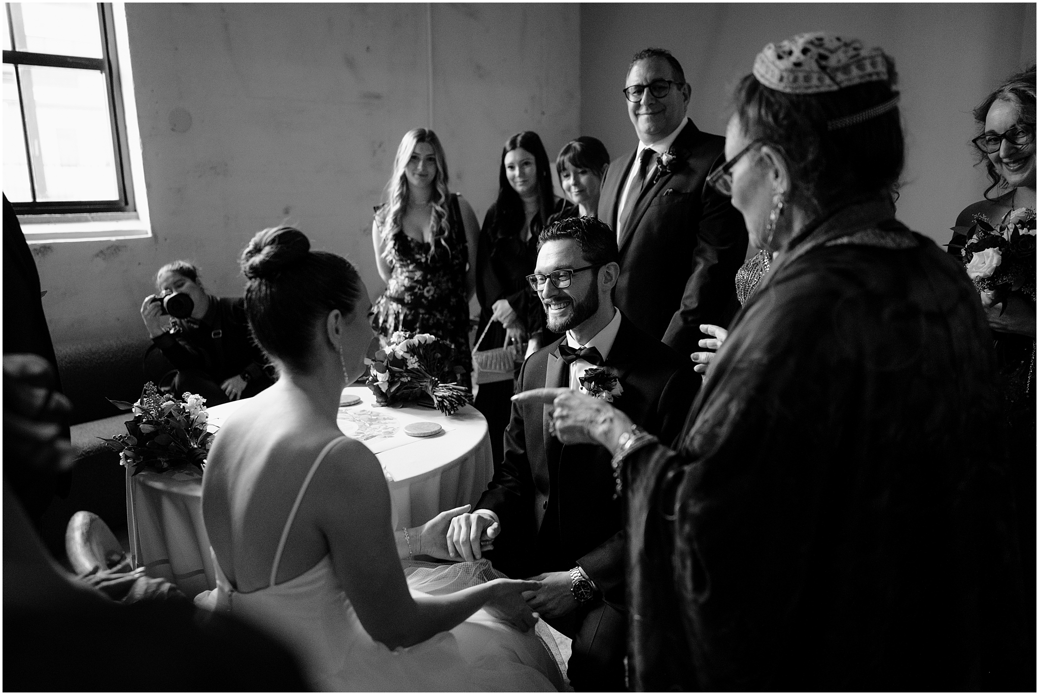 rabbi performs ceremony to sign ketubah for bride and groom