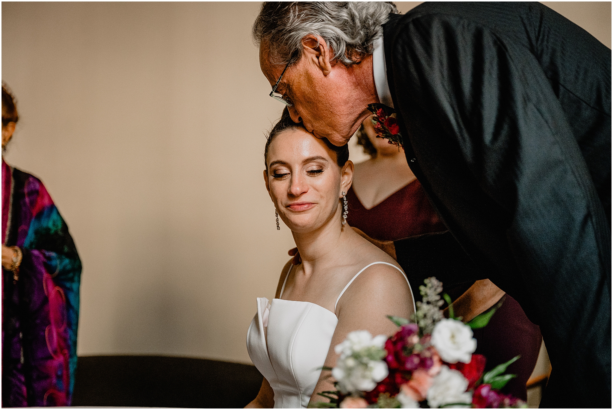 father kisses bride's forehead during wedding ceremony inside Cescaphe's Switch House in Philadelphia PA