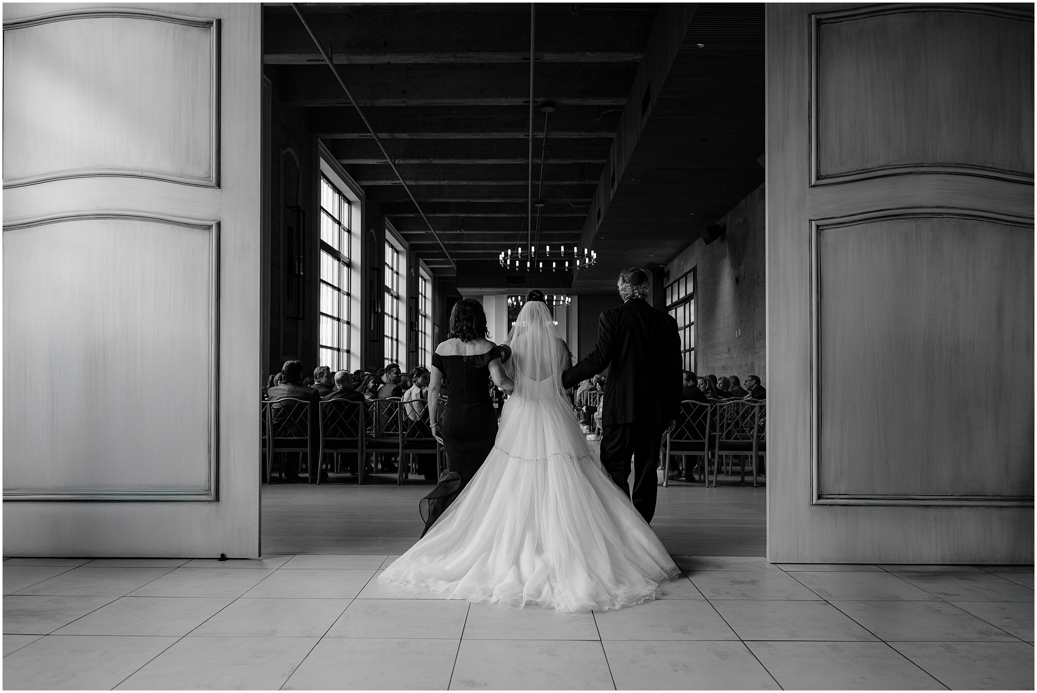 parents escort bride down aisle for Jewish wedding ceremony inside Cescaphe's Switch House in Philadelphia PA