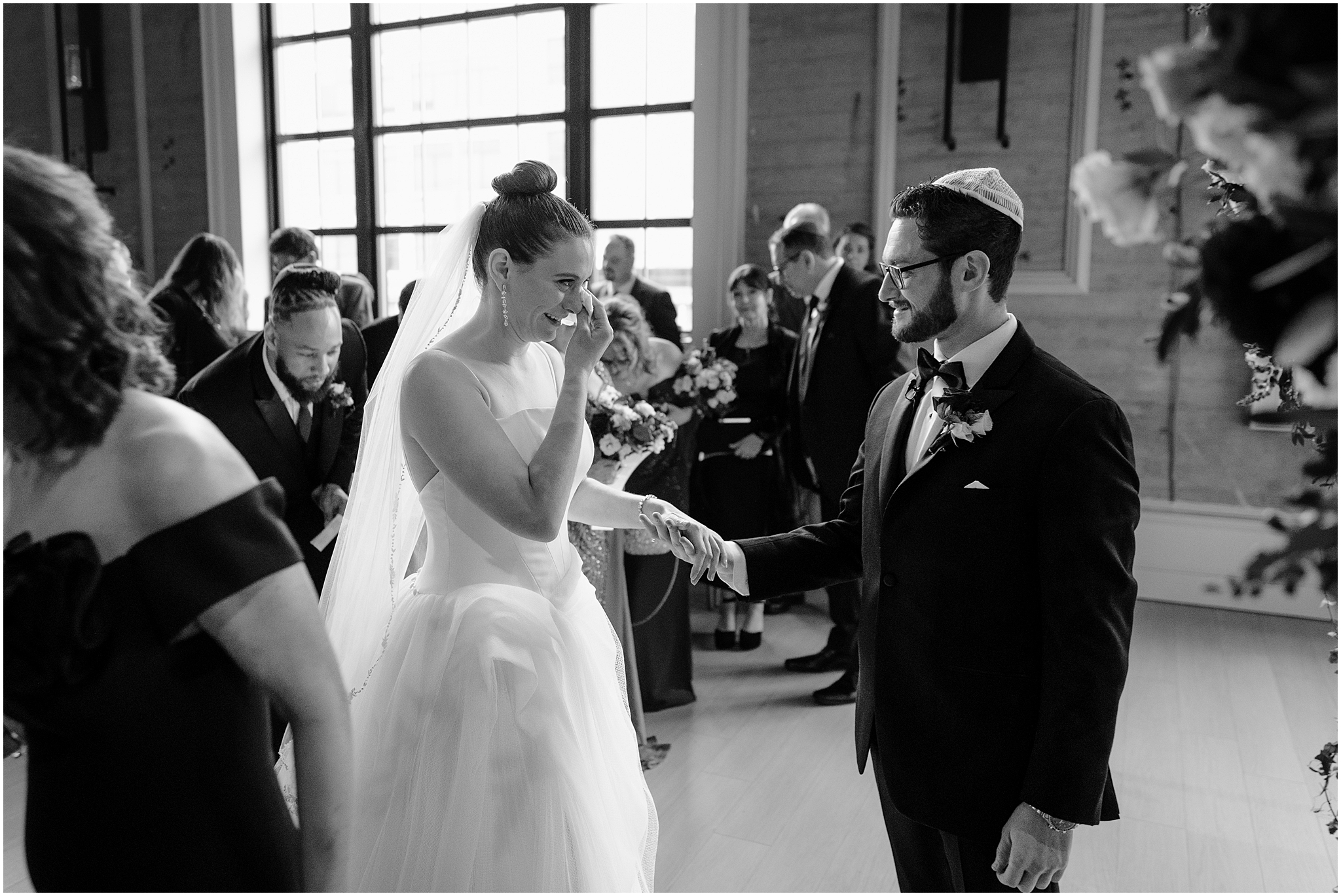 bride cries reaching for groom before their Jewish wedding ceremony inside Cescaphe's Switch House in Philadelphia PA