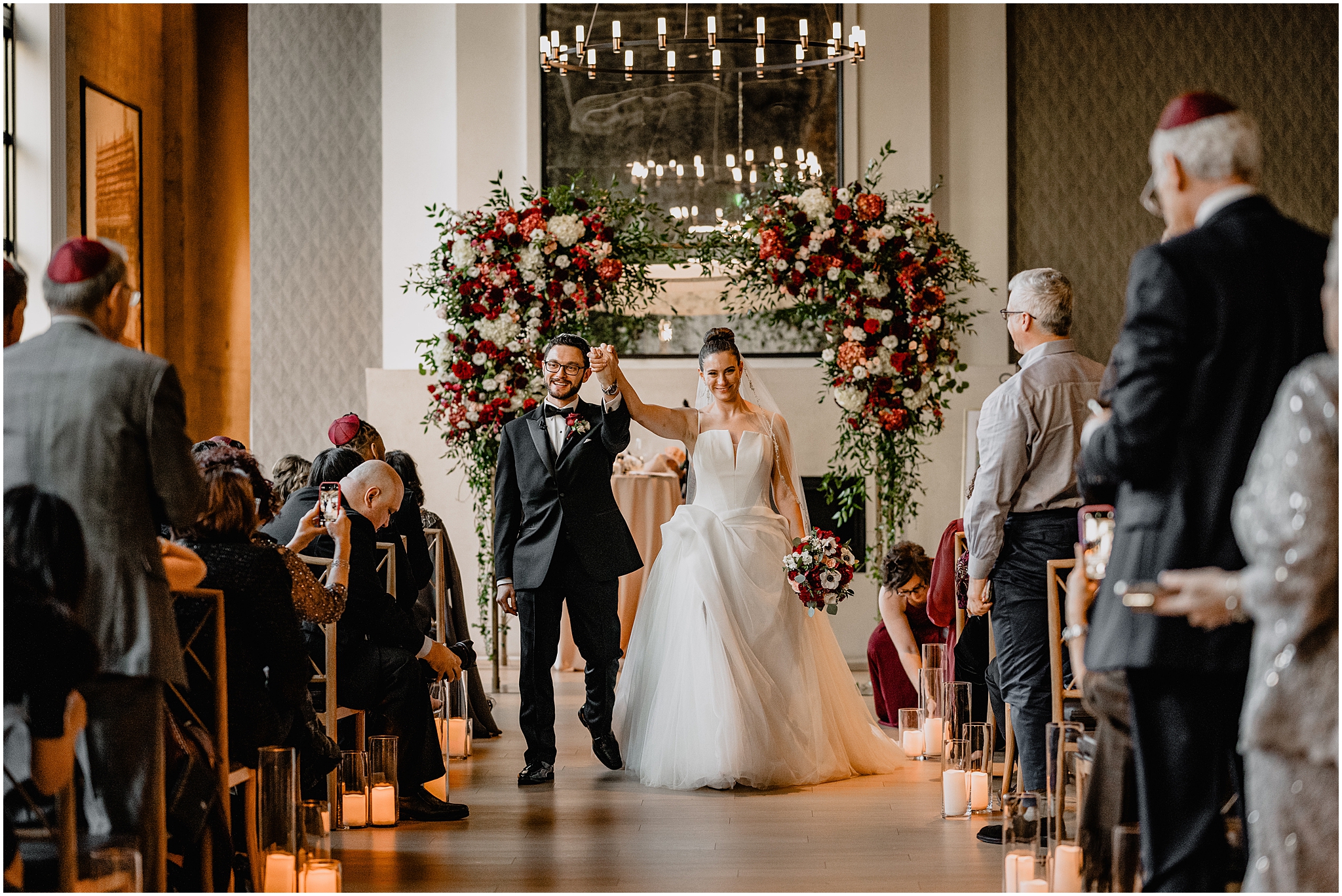 newlyweds cheer walking up aisle after Jewish wedding ceremony inside Cescaphe's Switch House in Philadelphia PA