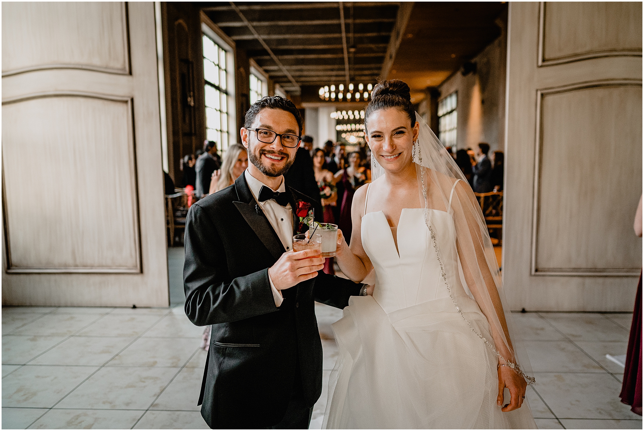 newlyweds toast signature drinks outside cocktail hour at Cescaphe's Switch House