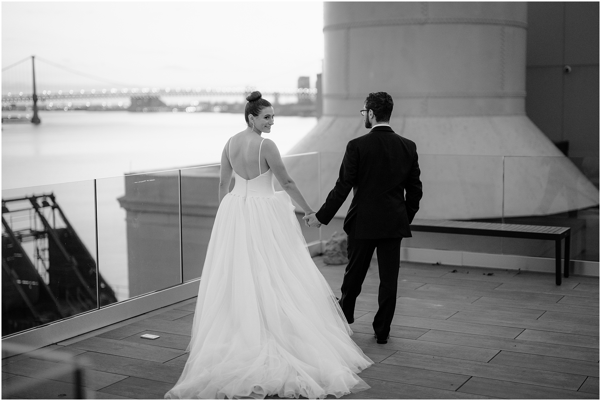 bride and groom hold hands walking on patio at Cescaphe's Switch House in Philly PA
