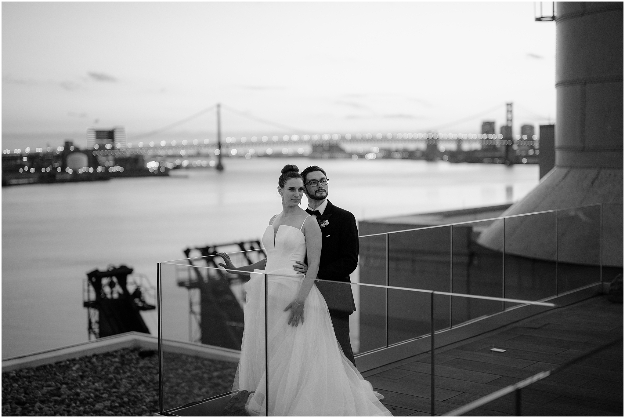 bride and groom pose in front of glass wall at Cescaphe's Switch House in Philly PA 