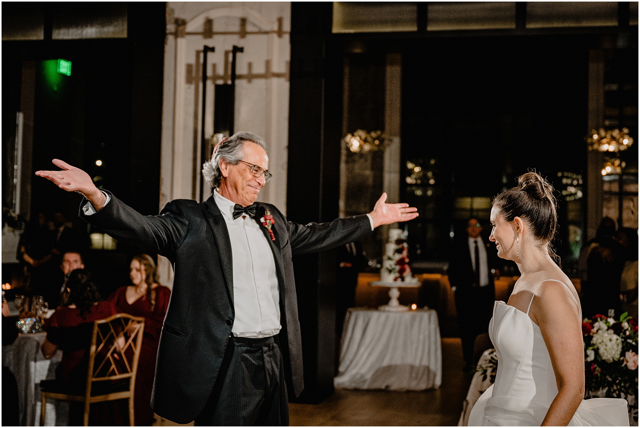 dad holds out arms for bride on dance floor during Philadelphia PA wedding reception in the ballroom