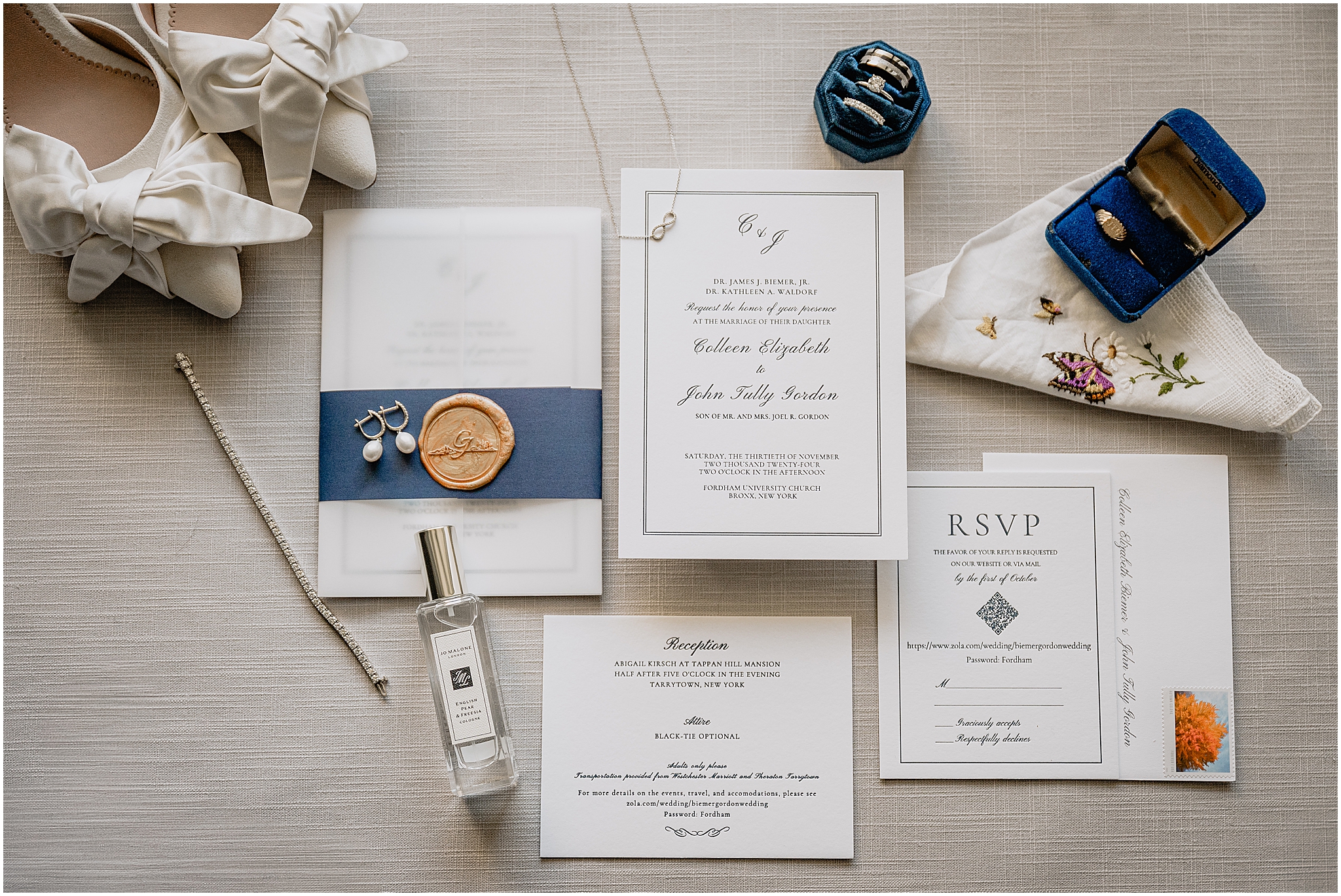wedding invitation with navy blue and gold wax seal with bride's details 