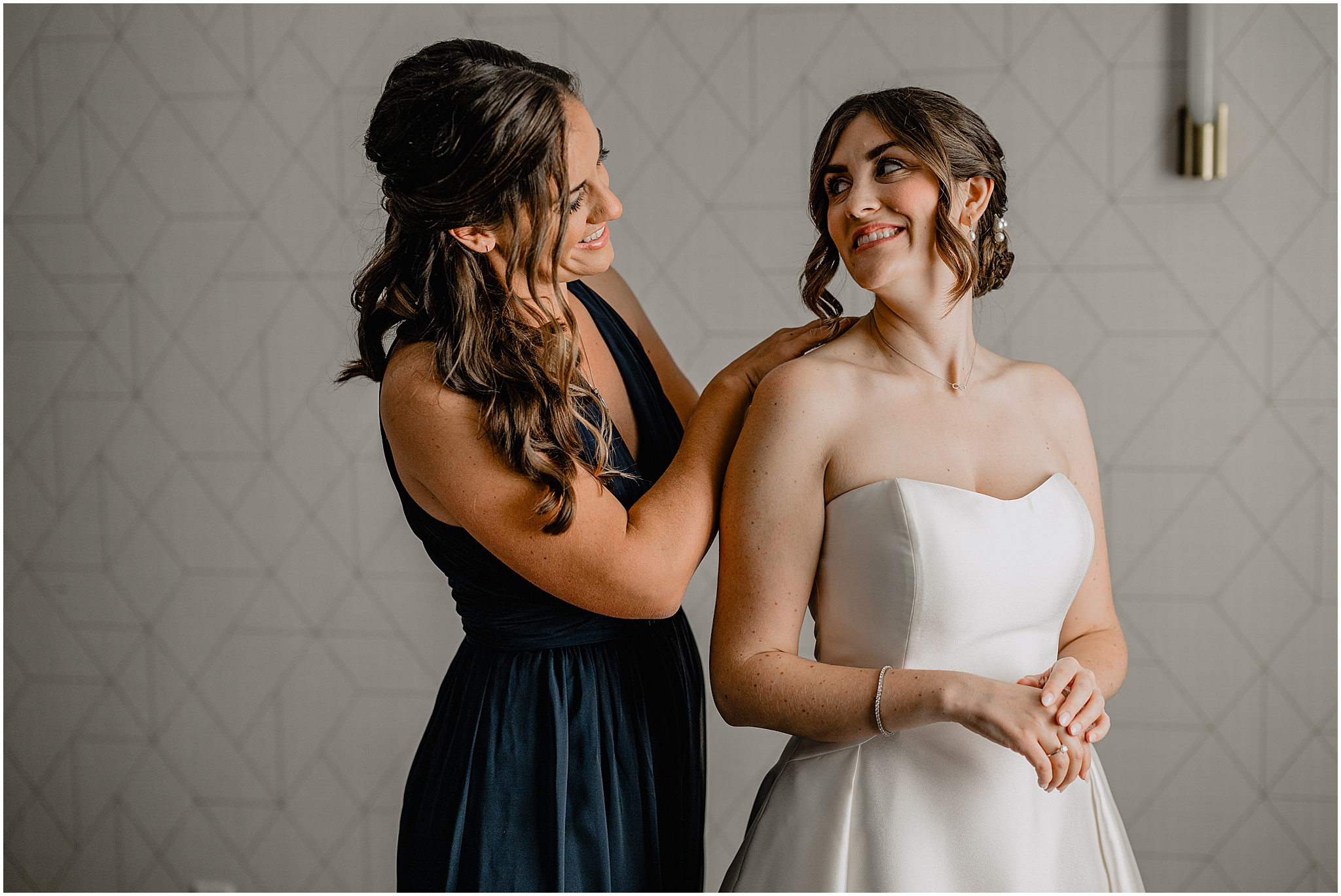 bridesmaid helps bride with necklace during prep at Hudson Valley hotel