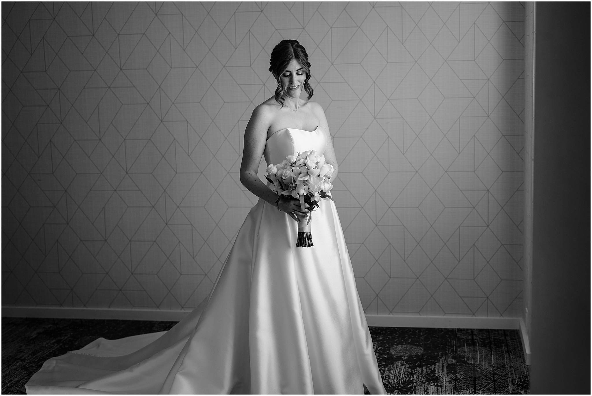 bride holds bouquet of white flowers during prep at Hudson Valley hotel