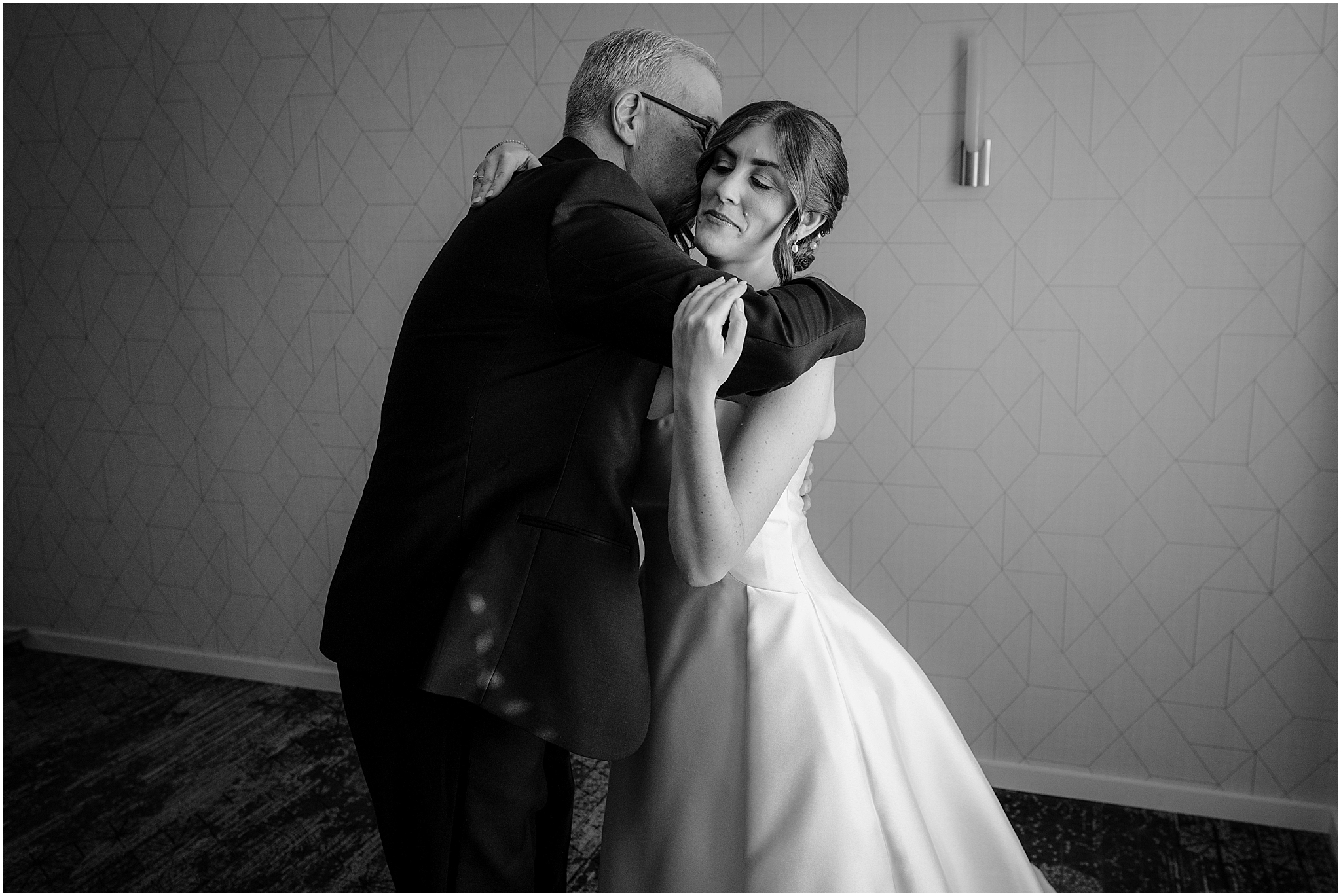 bride and dad hug during first look inside Hudson Valley hotel
