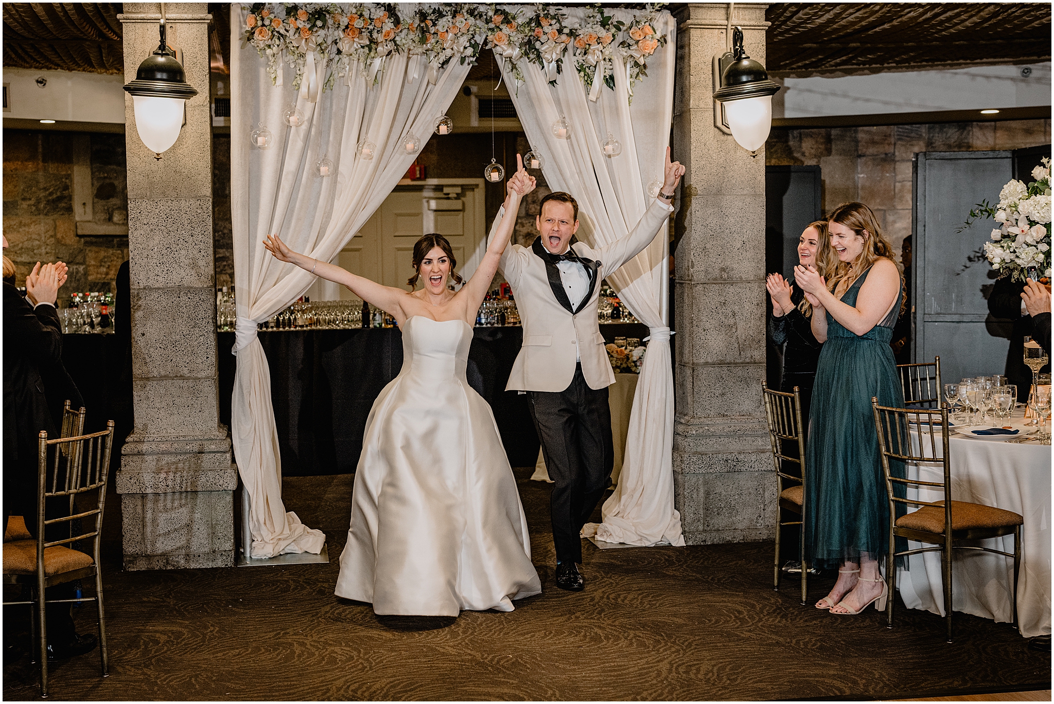 bride and groom cheer walking into wedding reception at Tappan Hill Mansion