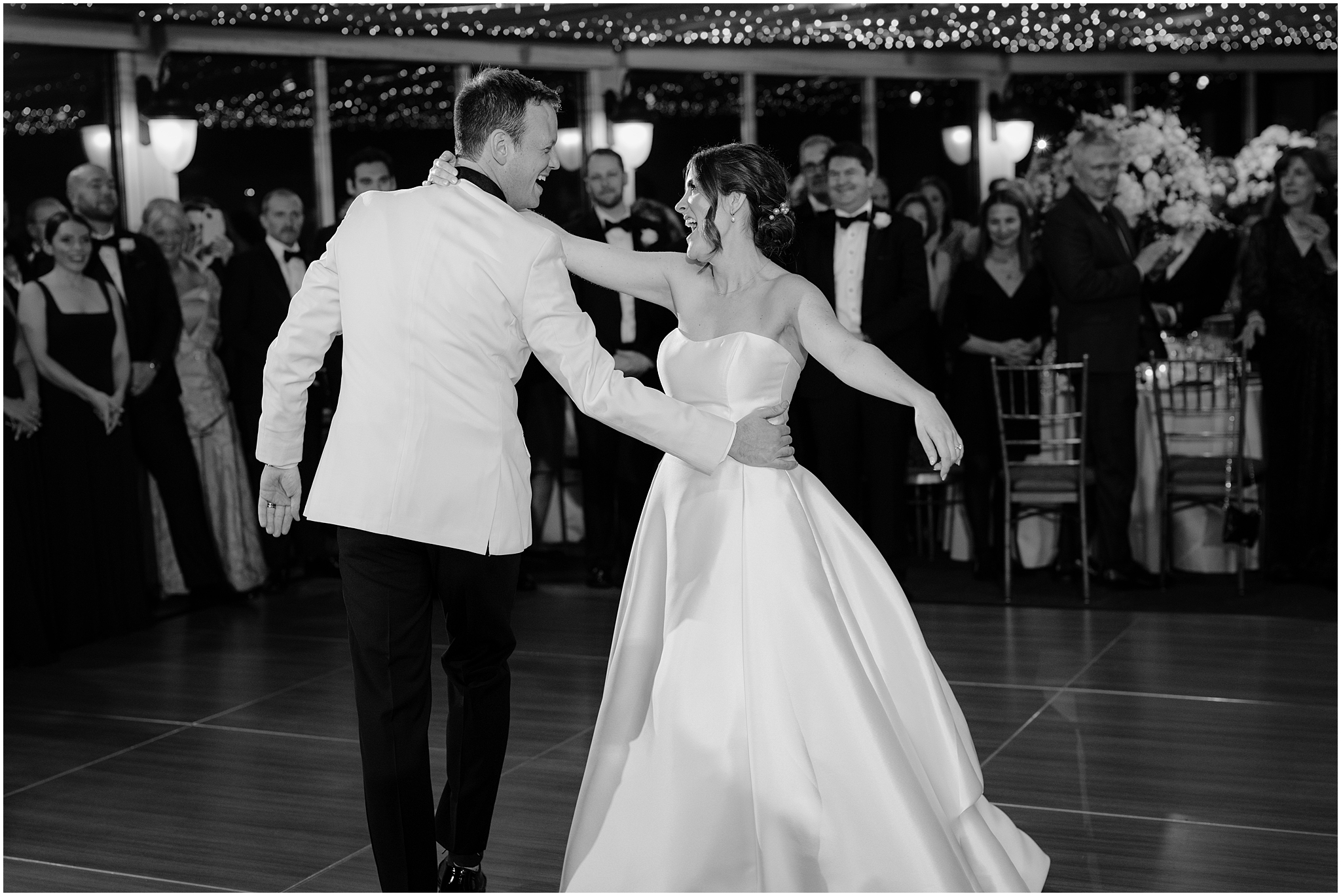 bride twirls around groom on dance floor inside Tappan Hill Mansion