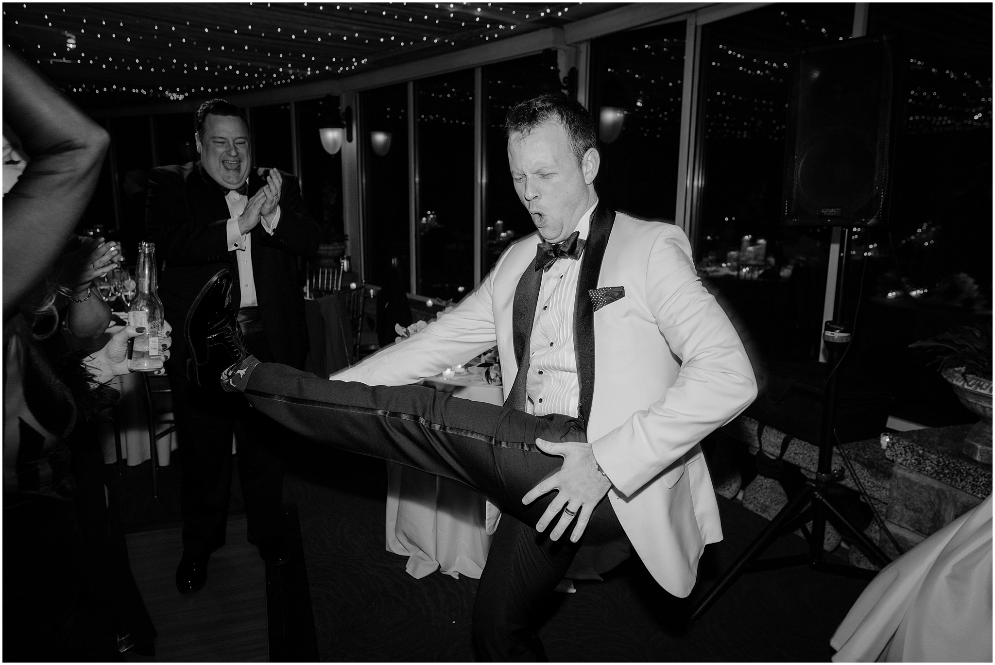 groom plays air guitar while dancing during Tarrytown NY wedding reception