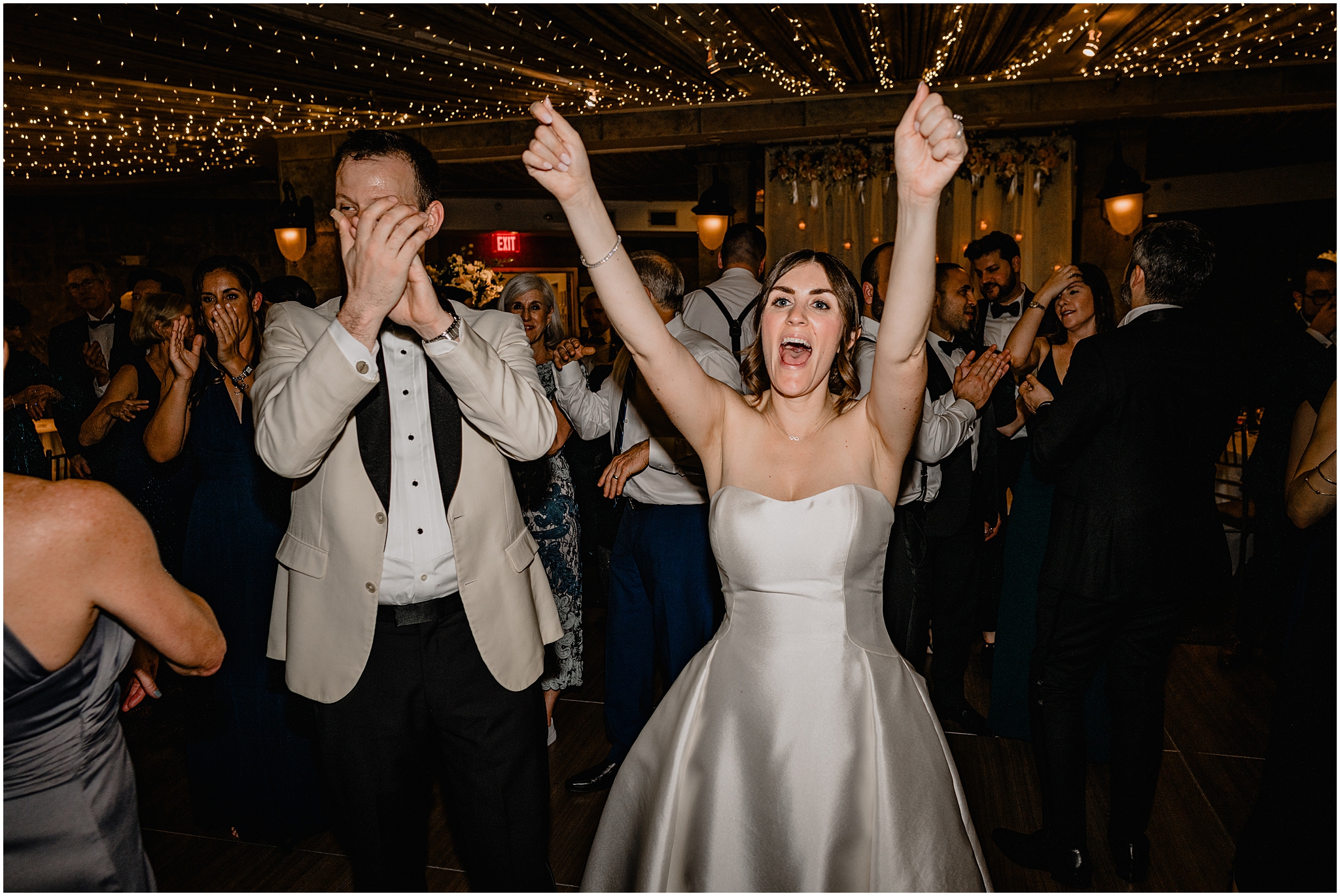 newlyweds cheer on dance floor at Tarrytown NY wedding reception