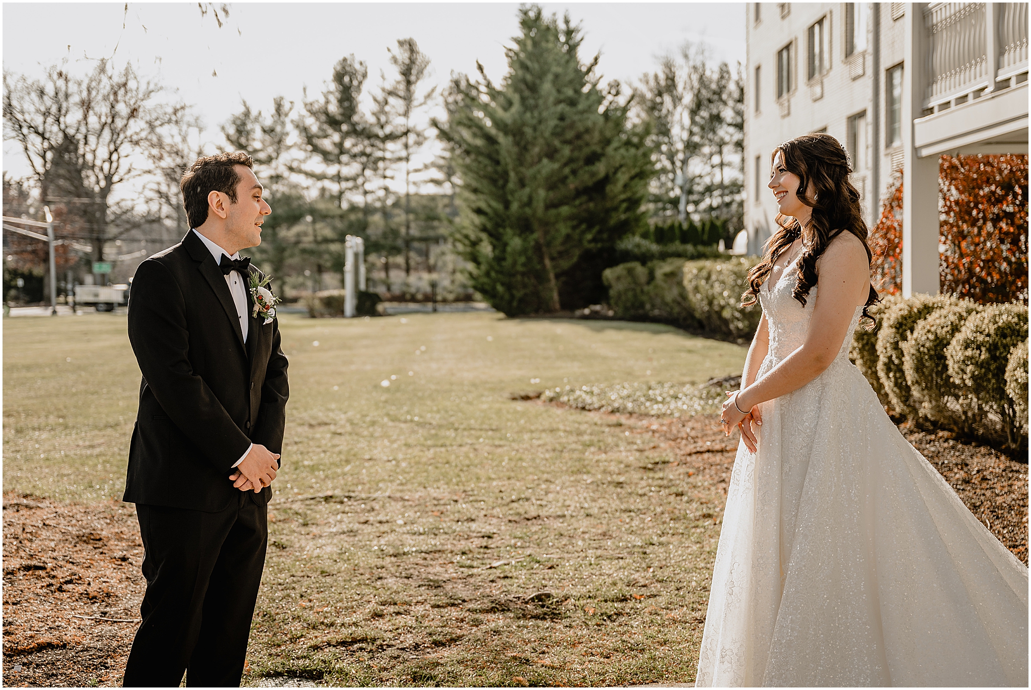 groom turns to look at bride during first look outside NJ hotel