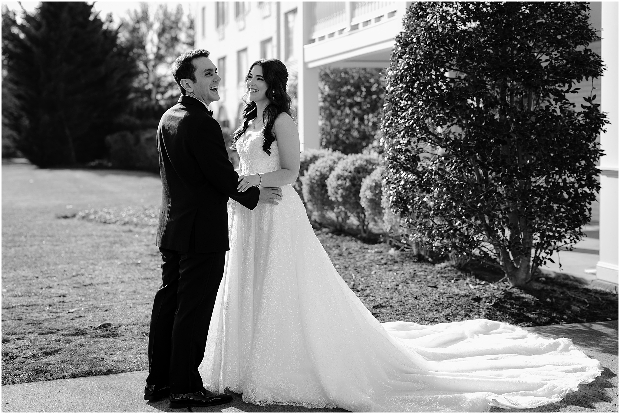 bride and groom laugh together outside New Jersey hotel during first look