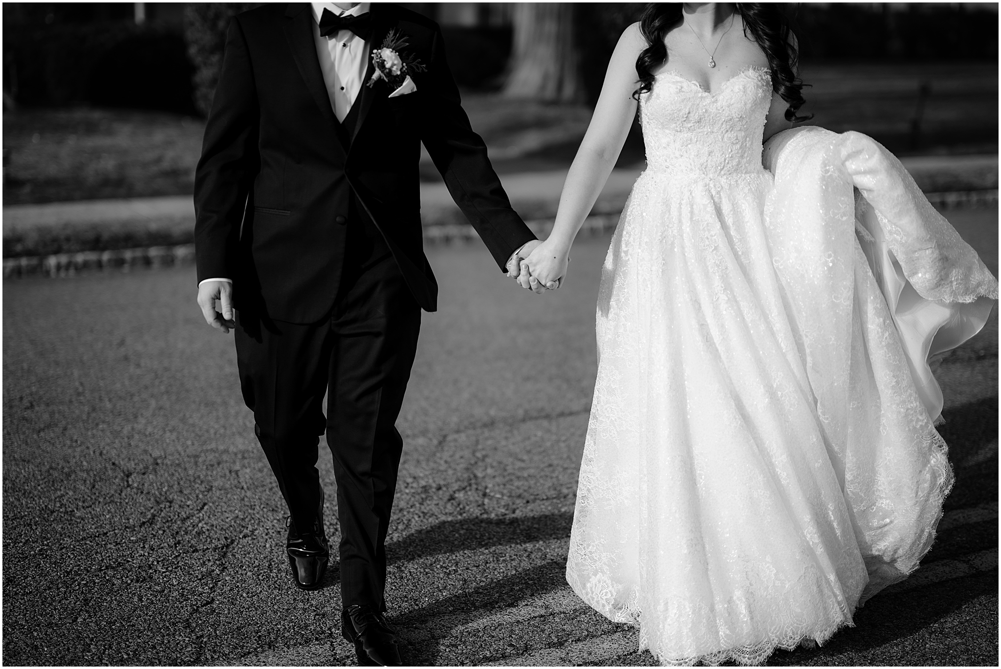 bride and groom hold hands walking across parking lot in New Jersey