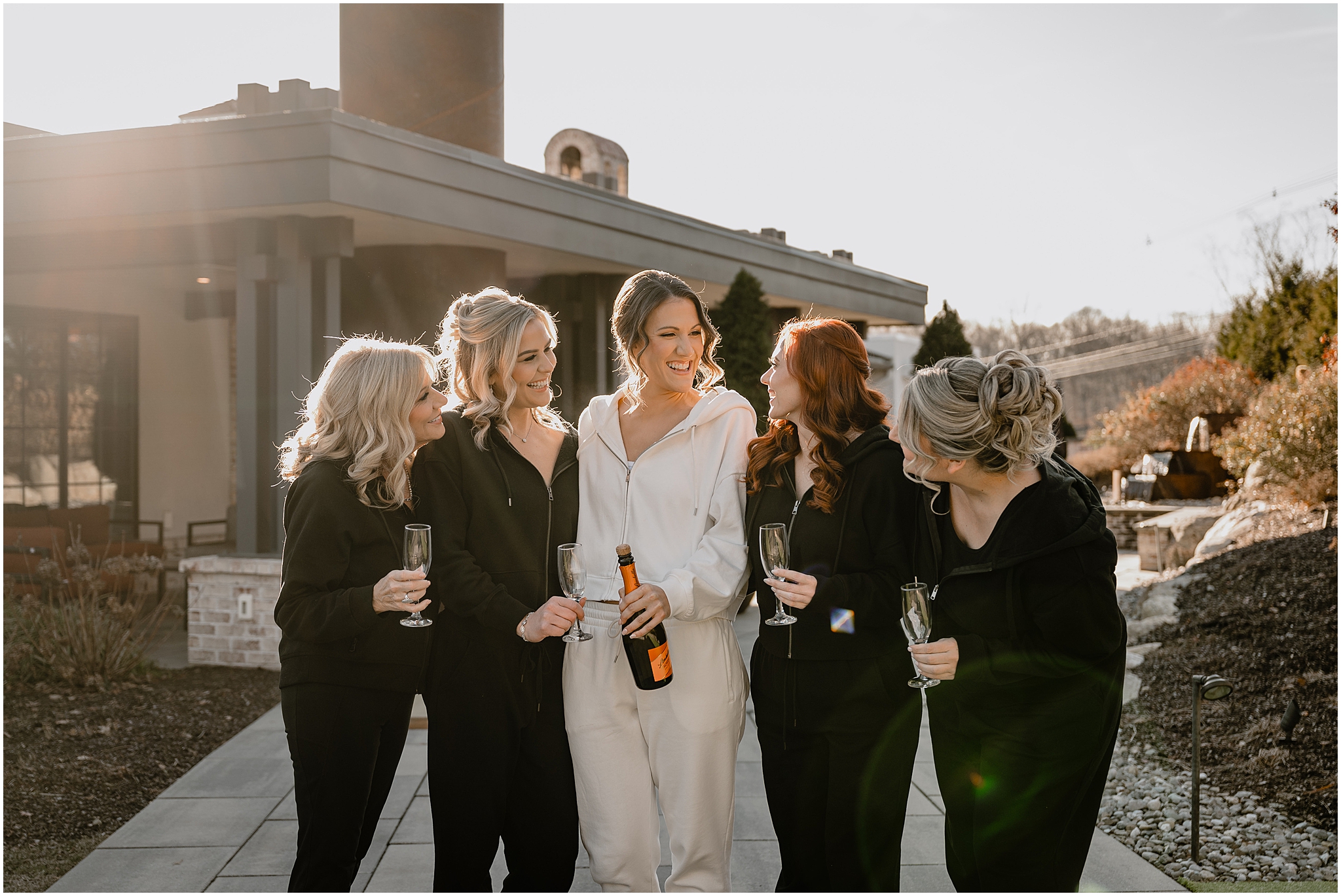 Bride with her bridesmaid before her winter wedding at Perona Farms Refinery.