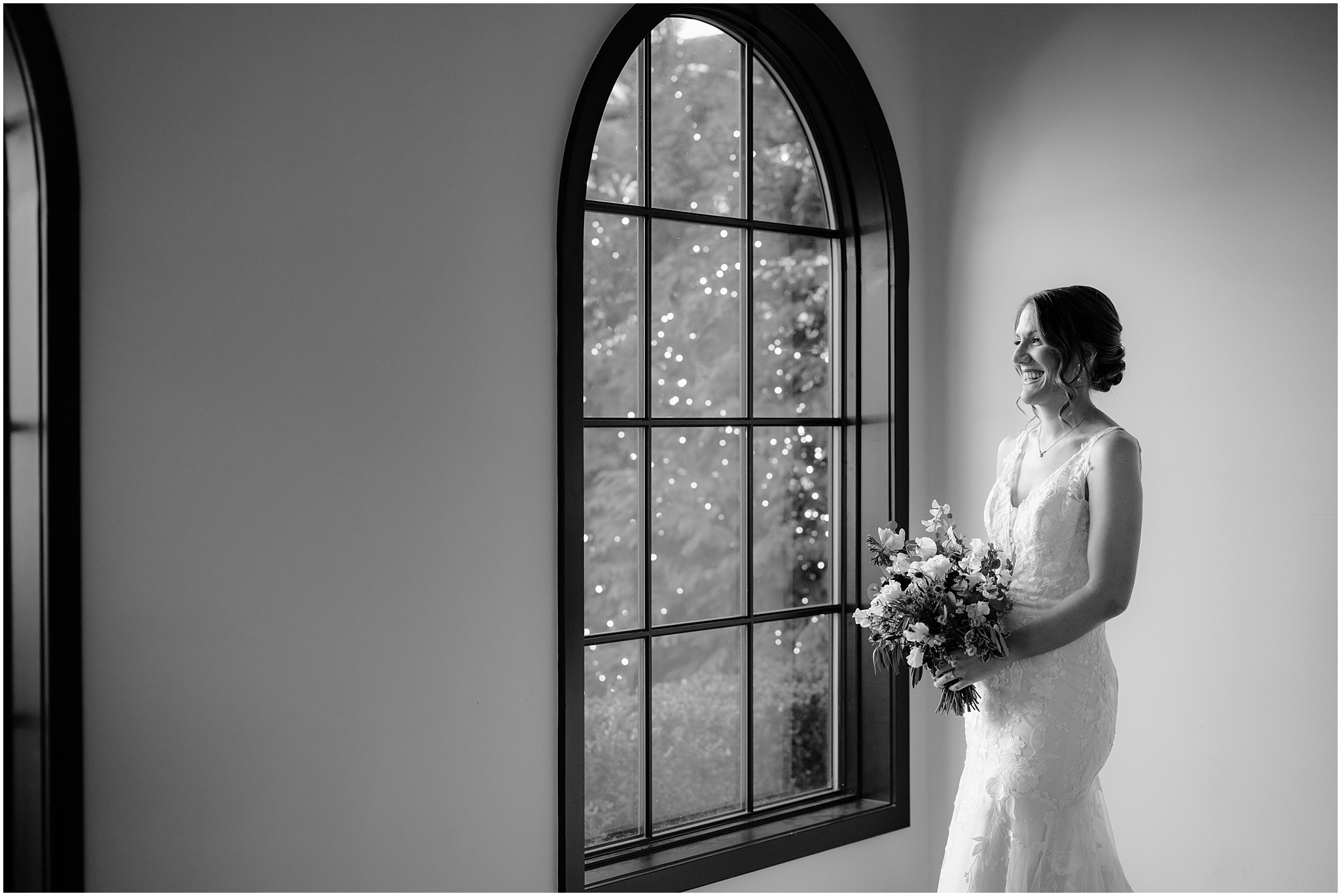 Bride by the window before her winter wedding at Perona Farms Refinery.