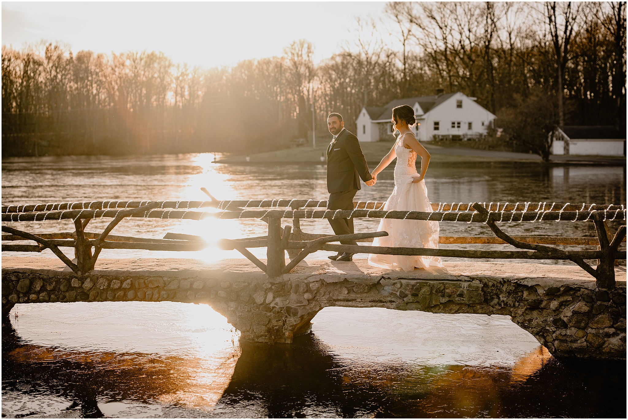 Couple on the bridge before their winter wedding at Perona Farms Refinery.