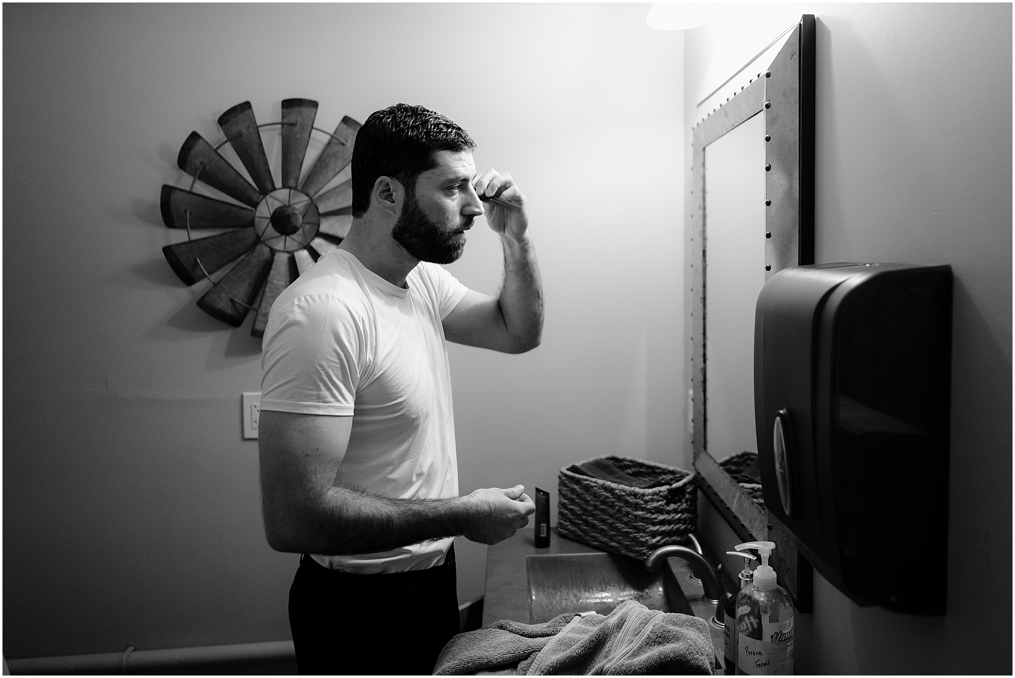 Groom getting ready before his winter wedding at The Barn at Perona Farms.