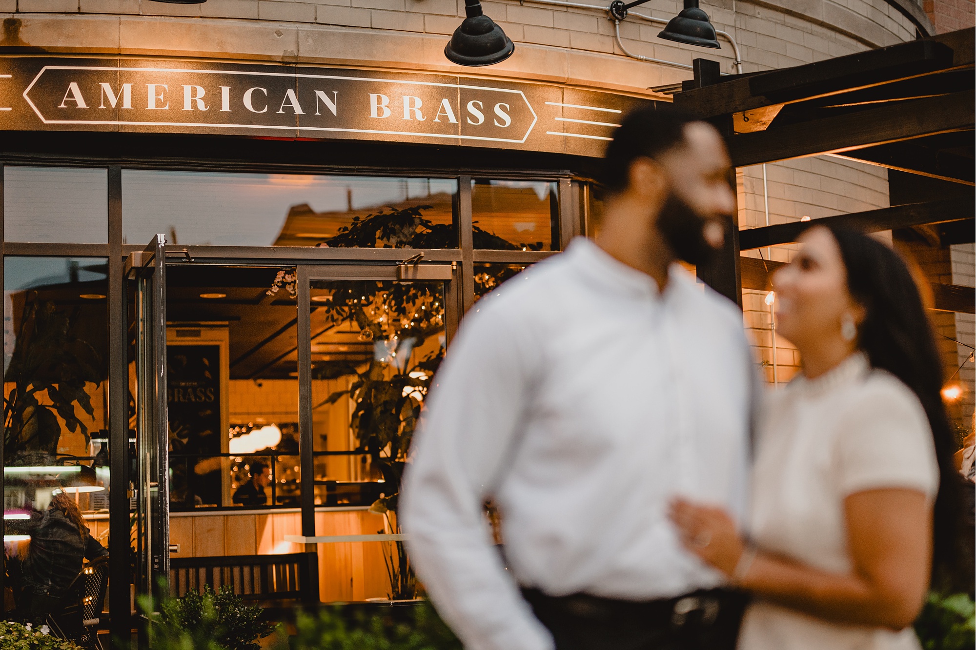 man and woman hug outside American Brass in Long Island City