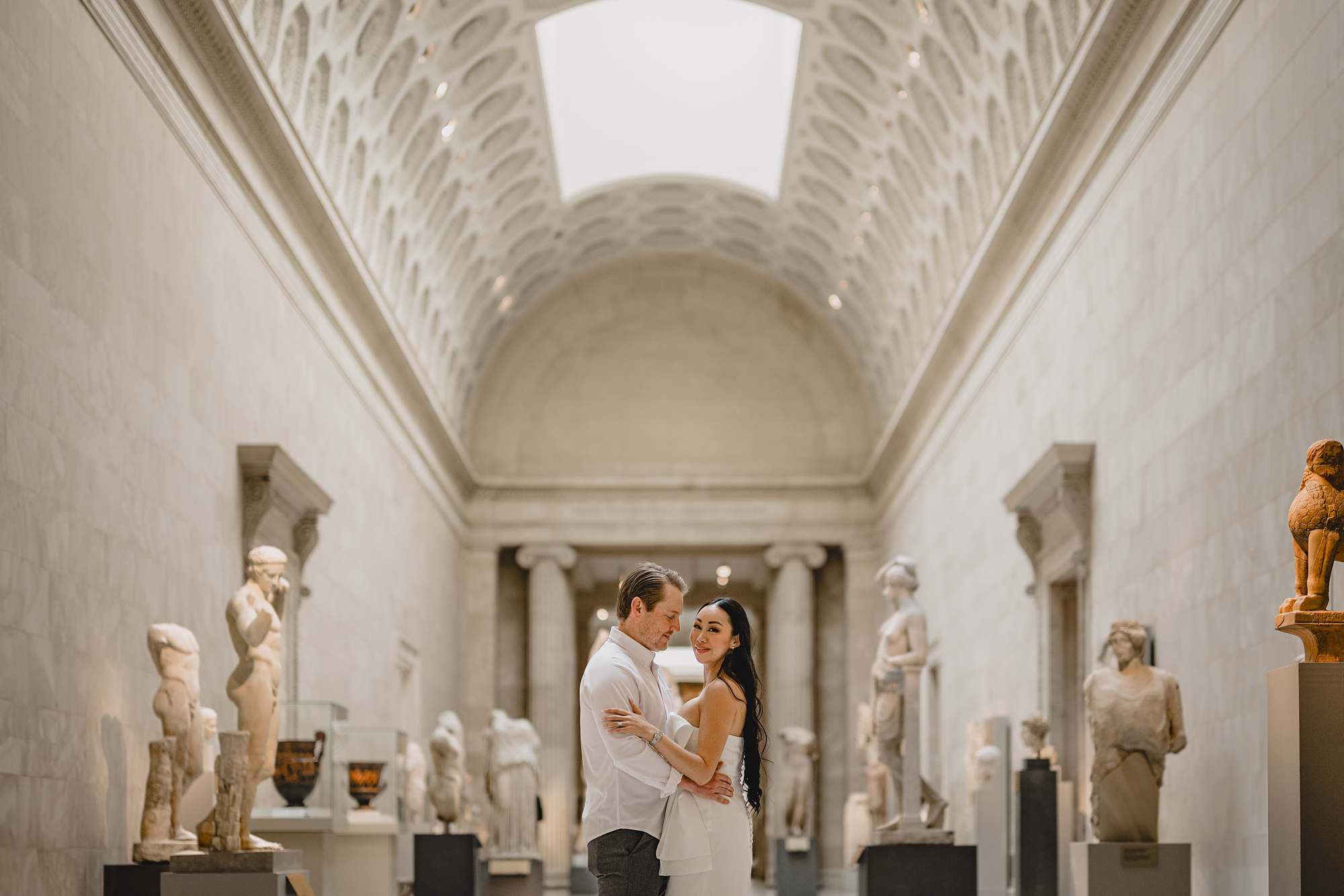 newlyweds hug inside exhibit during engagement session at the Met Museum in NYC