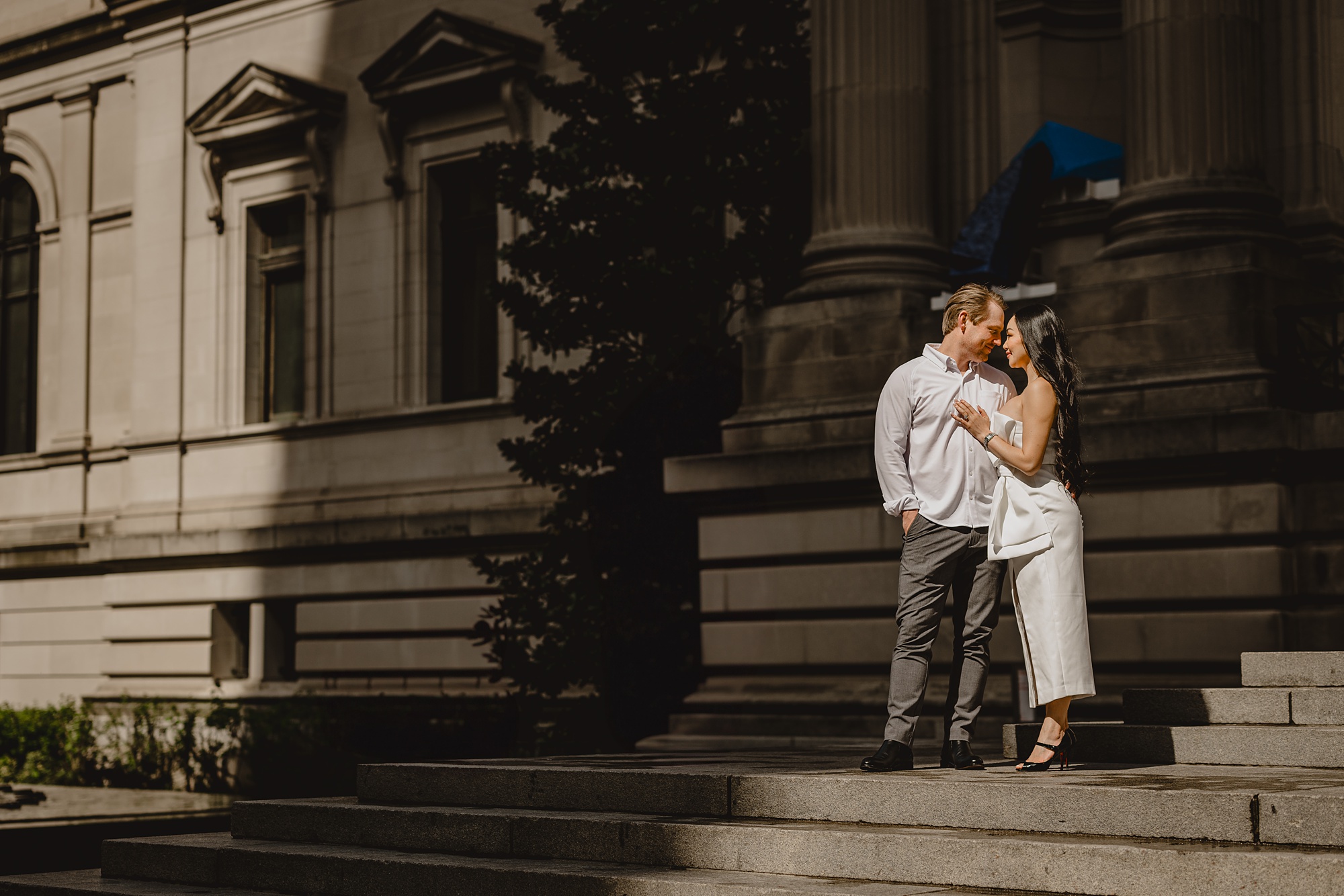man and woman stand on steps outside the Met Museum