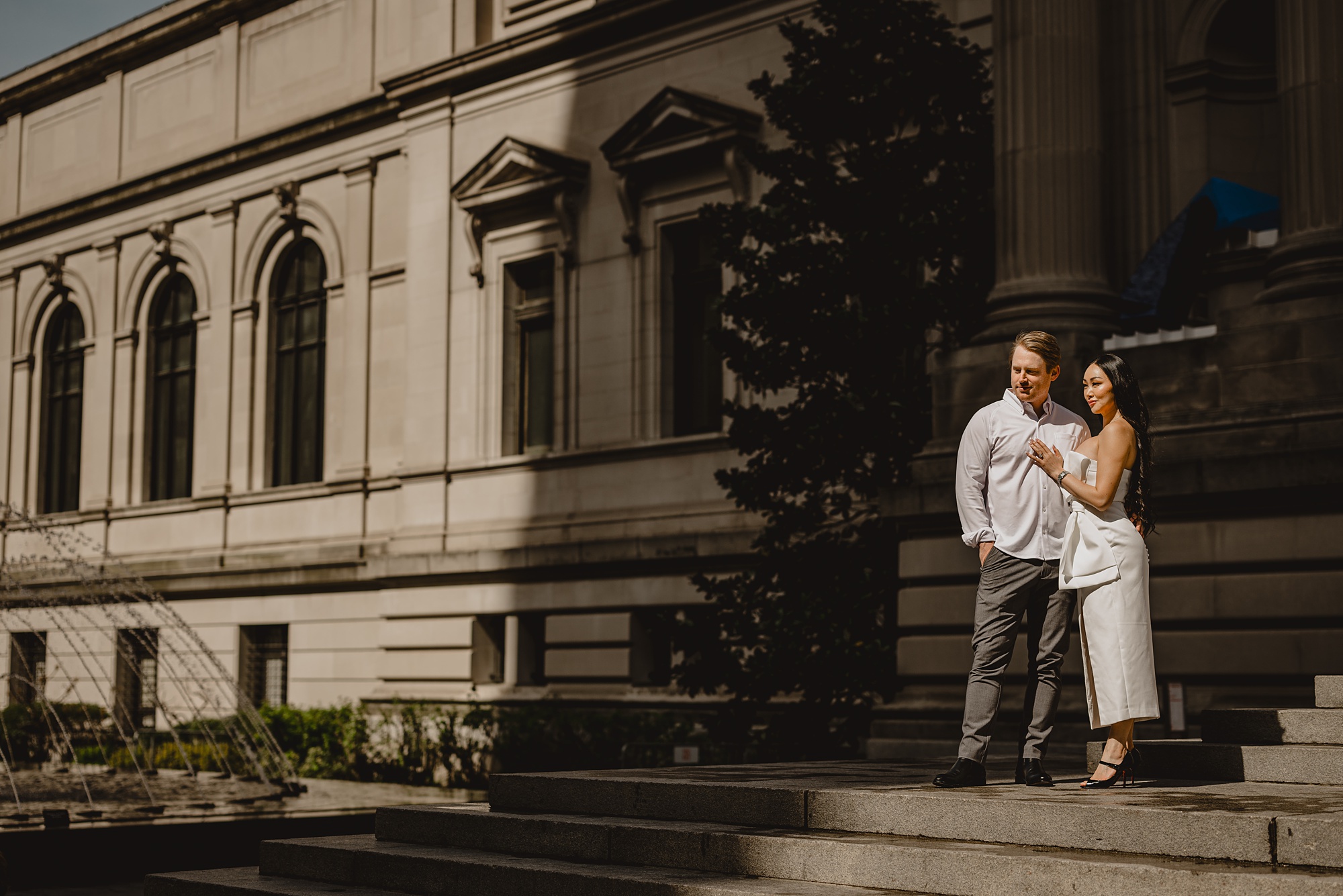 man and woman stand on steps outside the Met Museum