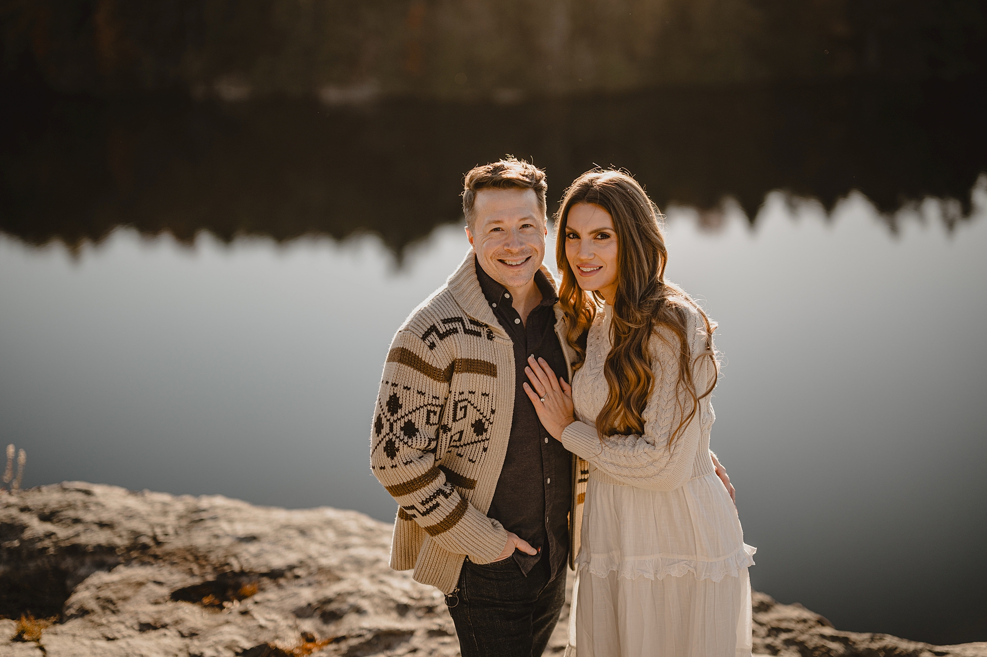 engaged couple stands in front of Lake Minnewaska