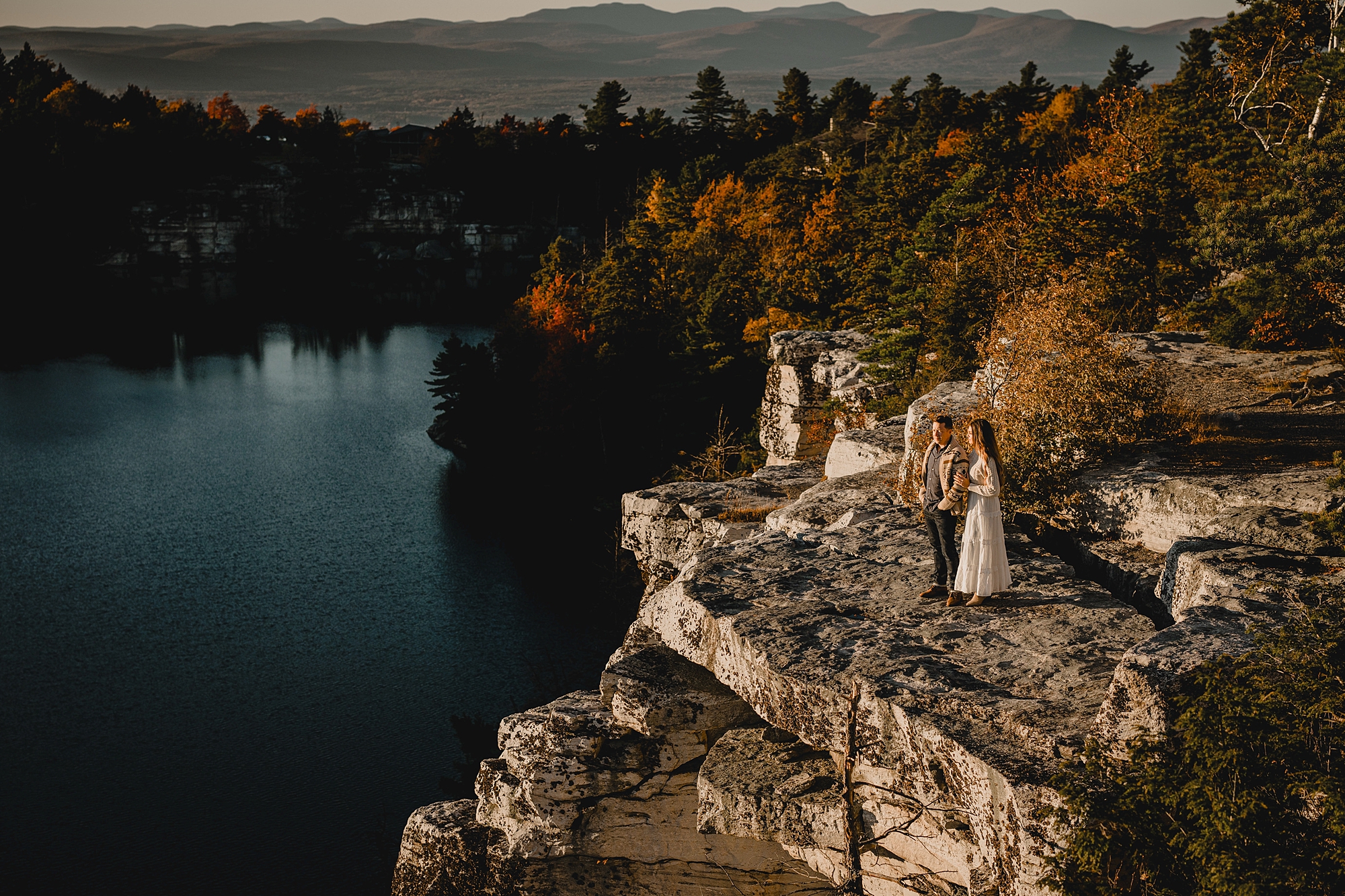 arial view of couple on cliff overlooking Lake Minnewaska