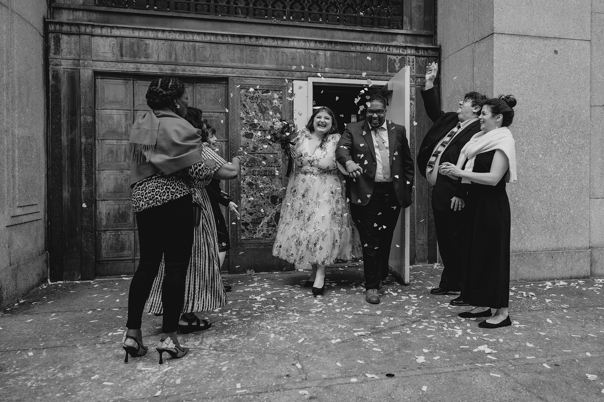 couple smiles leaving NYC City Hall after elopement