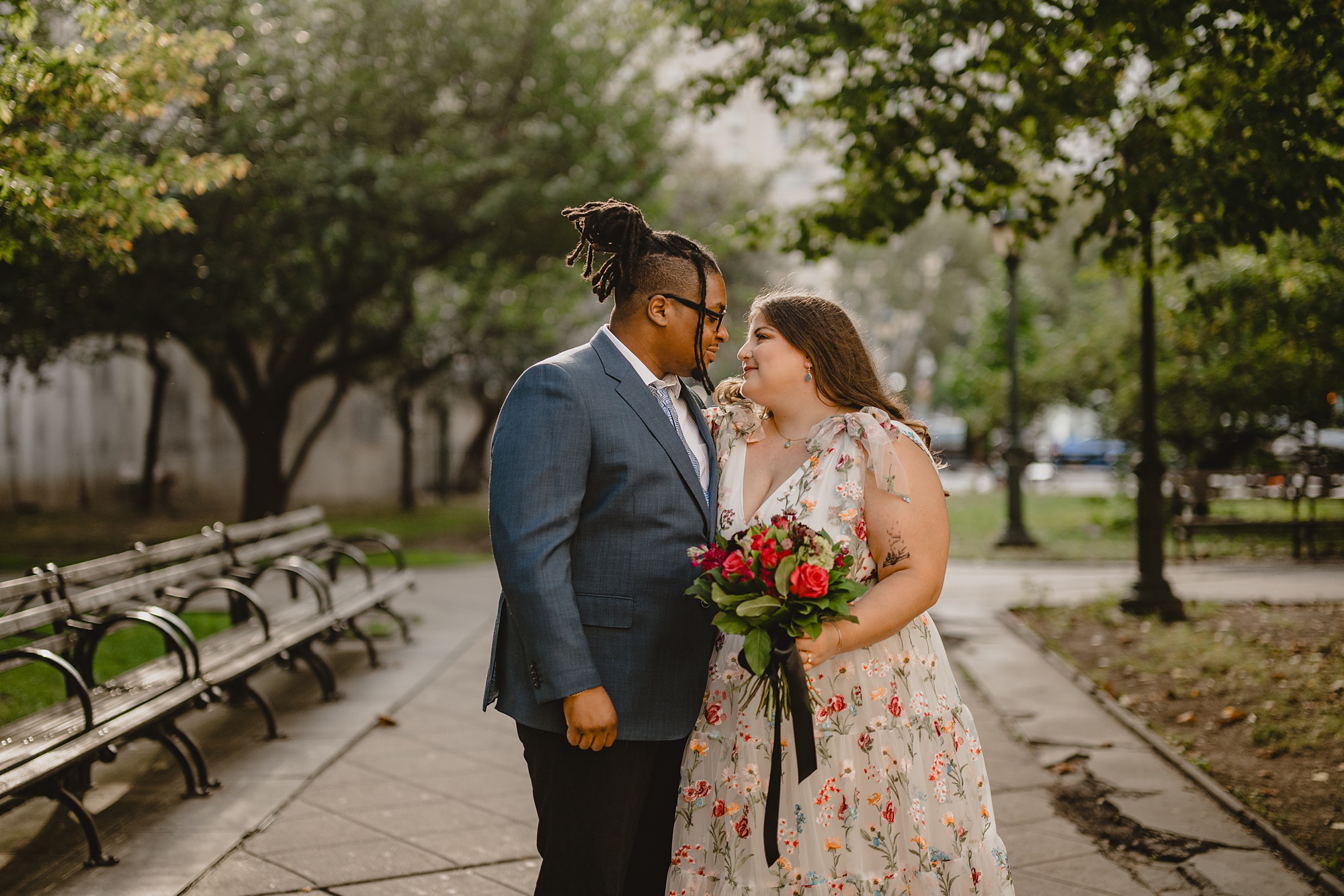 bride and groom smile at each other in New York City park