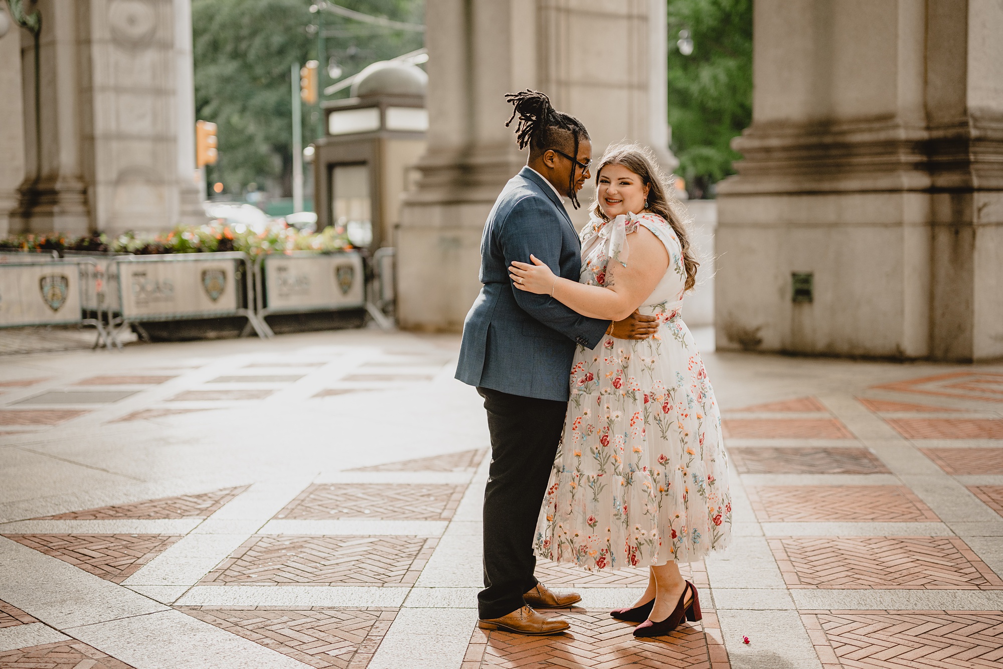 man hugs women around waist during portraits at NYC City Hall