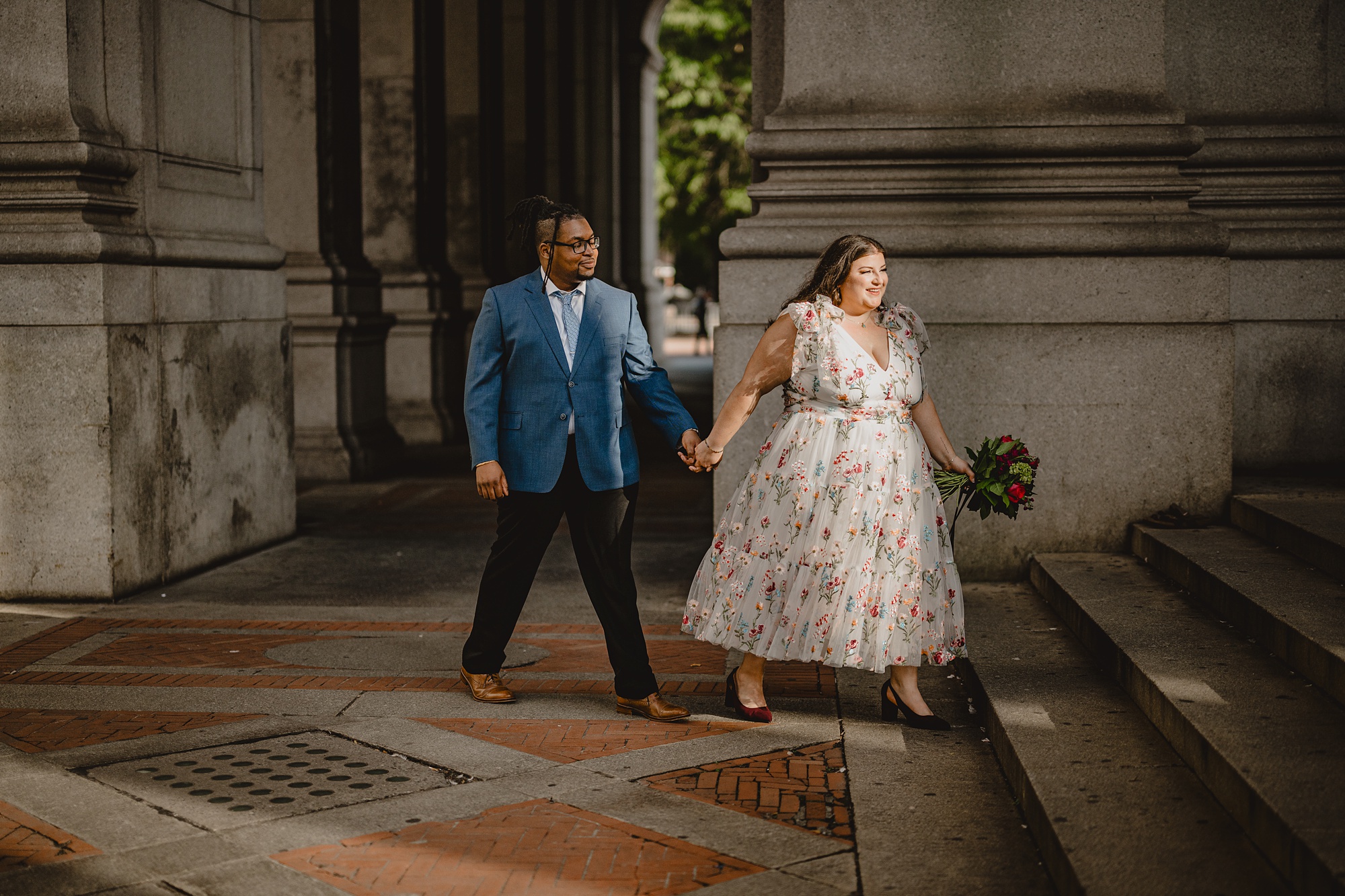 woman leads man up staircase inside Central Park on wedding day