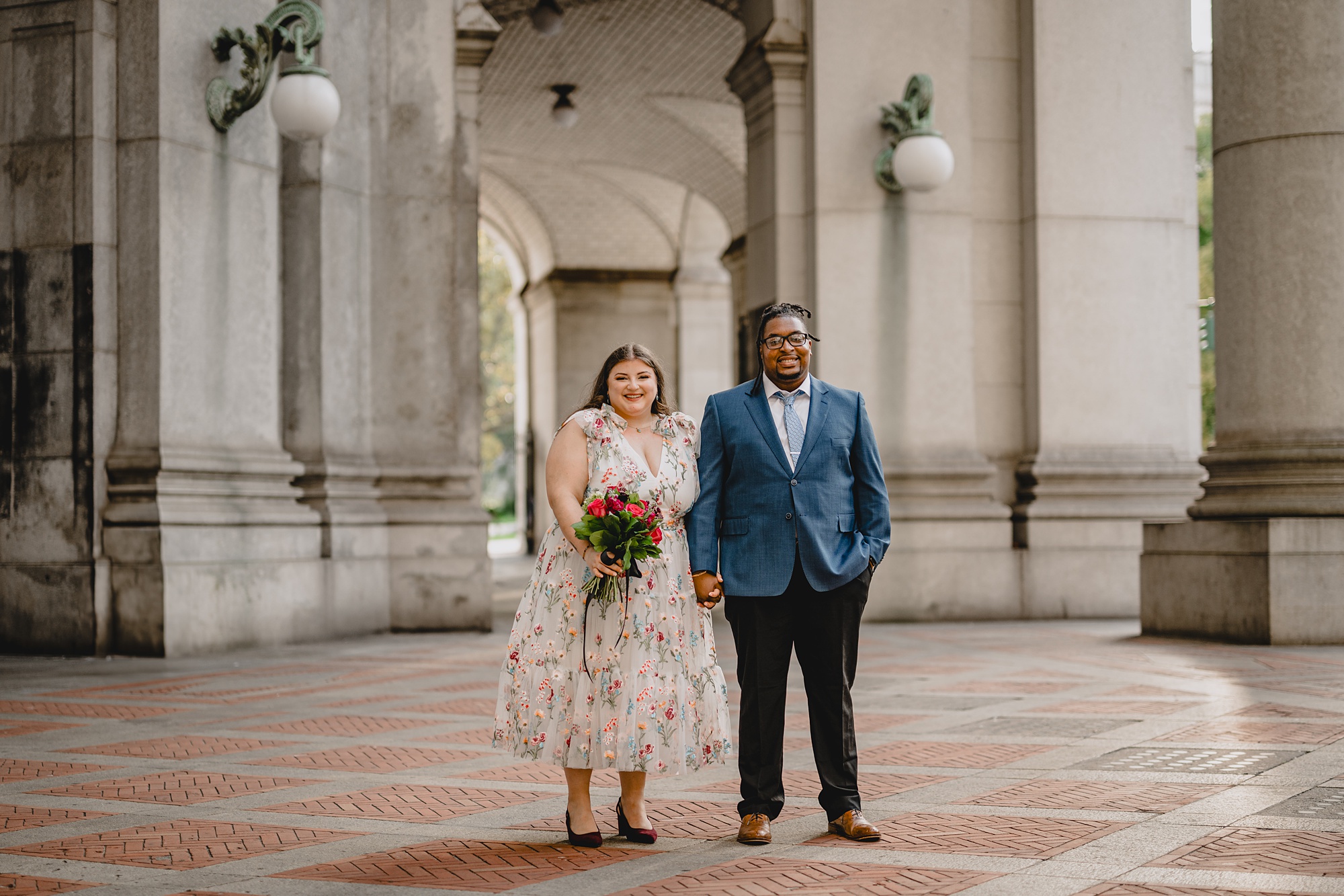 bride and groom stand together at NYC City Hall