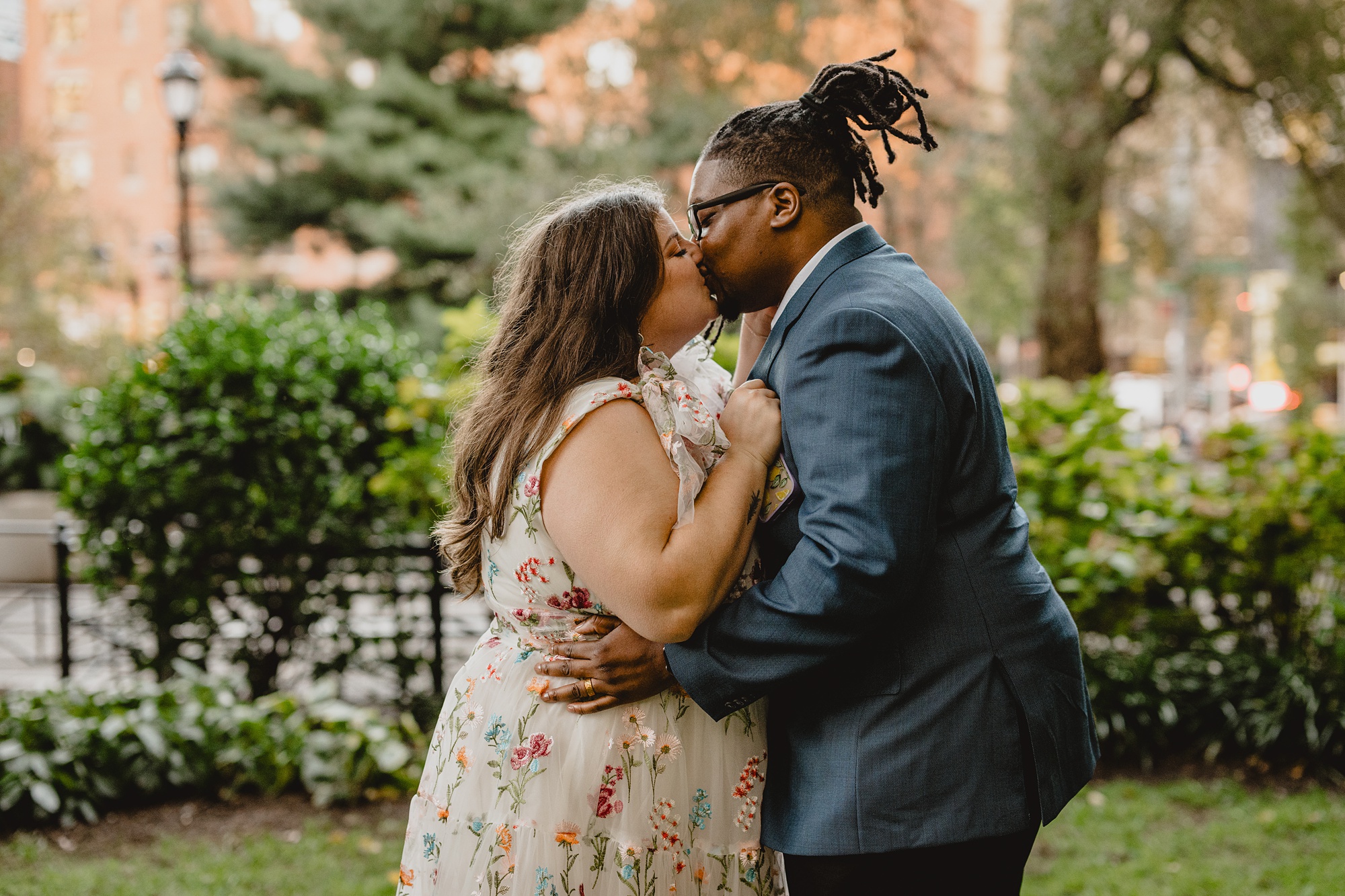 bride and groom kiss together inside NYC park