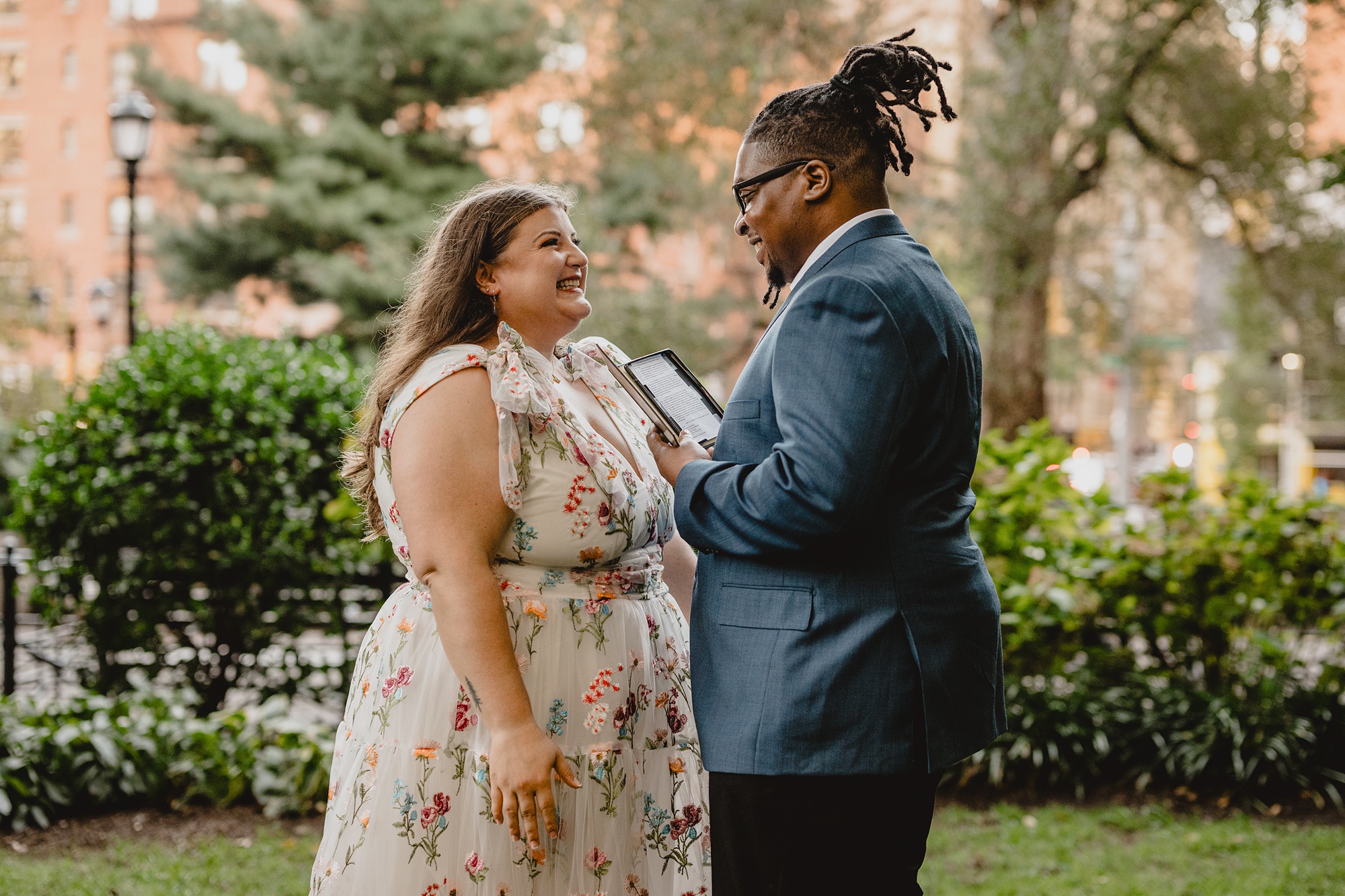 groom reads vows to bride during private elopement in NYC park