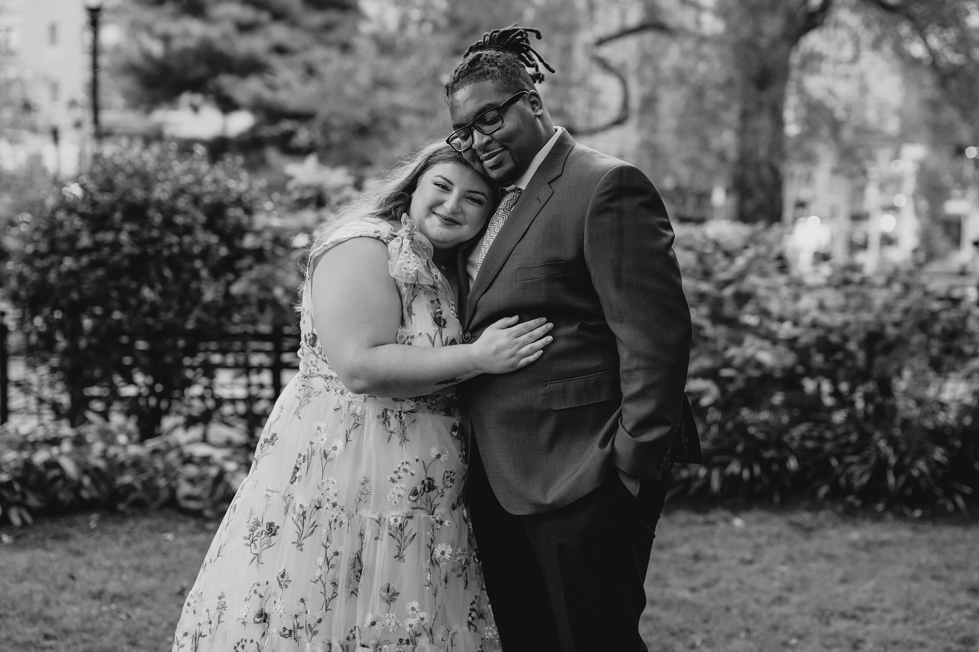 woman leans head on groom's chest inside NYC park