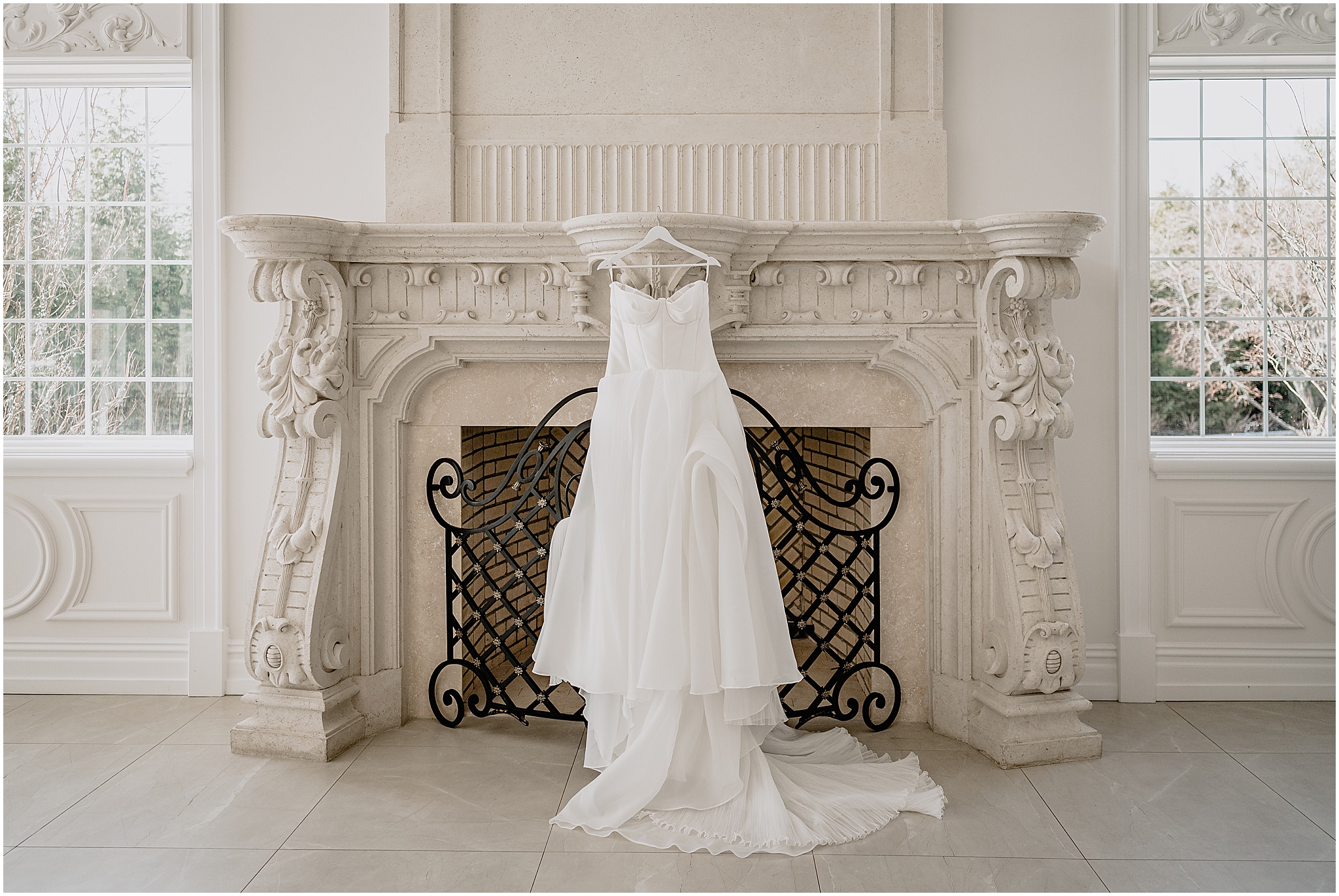 wedding dress hangs on fireplace inside the Estate at Florentine Gardens