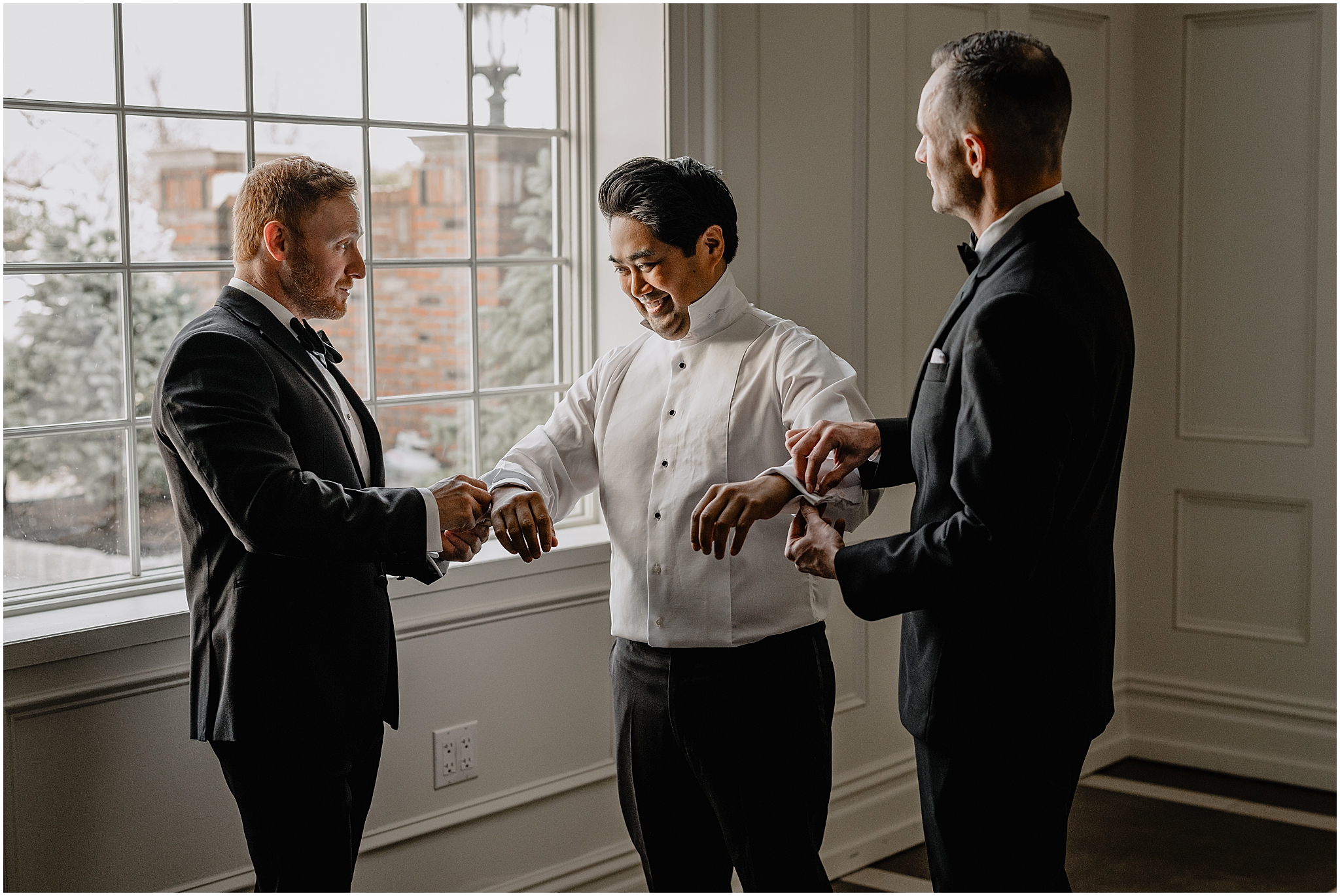 groomsman and father help groom adjust cufflinks before wedding day in New Jersey 