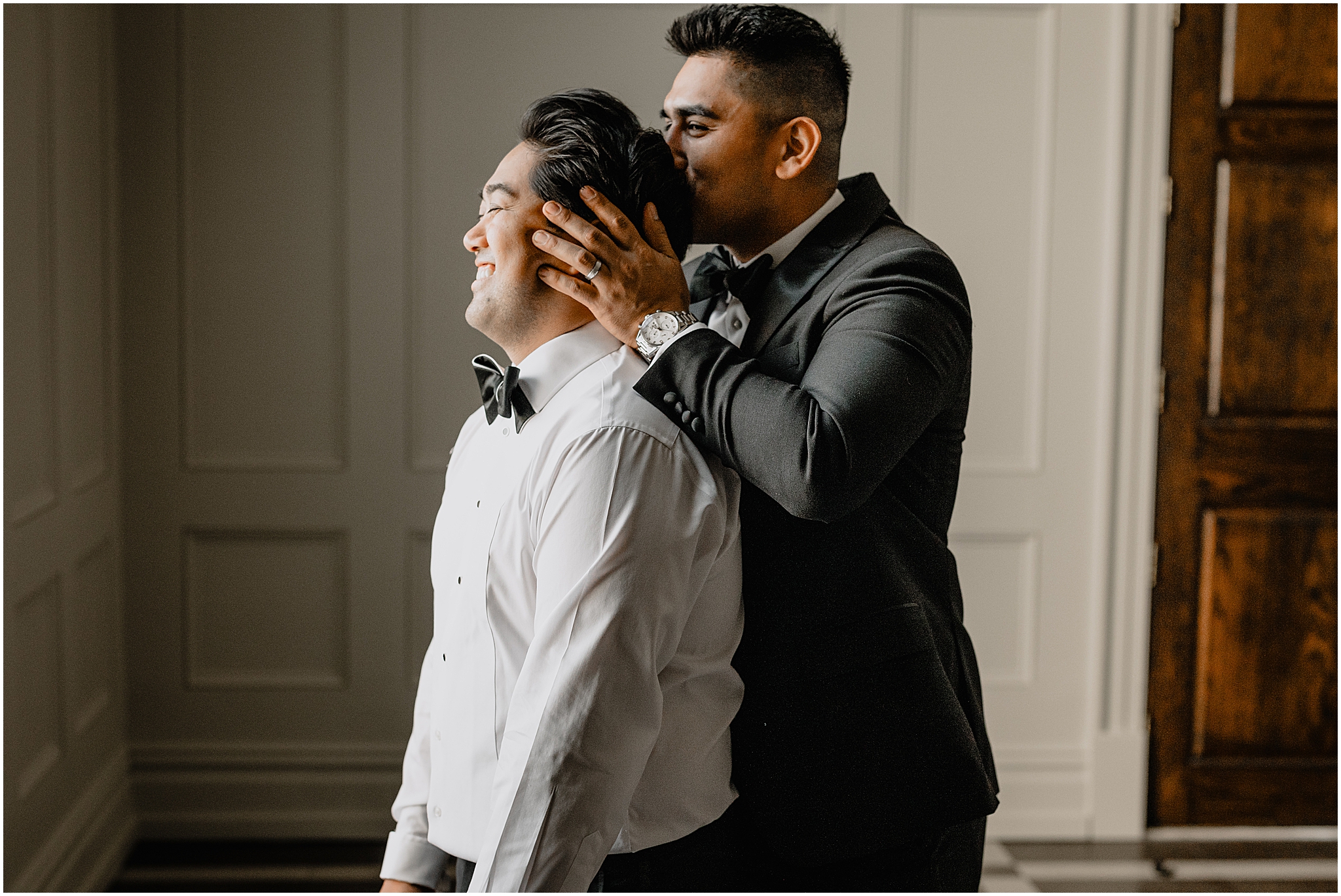 man kisses back of groom's head during prep for NJ wedding